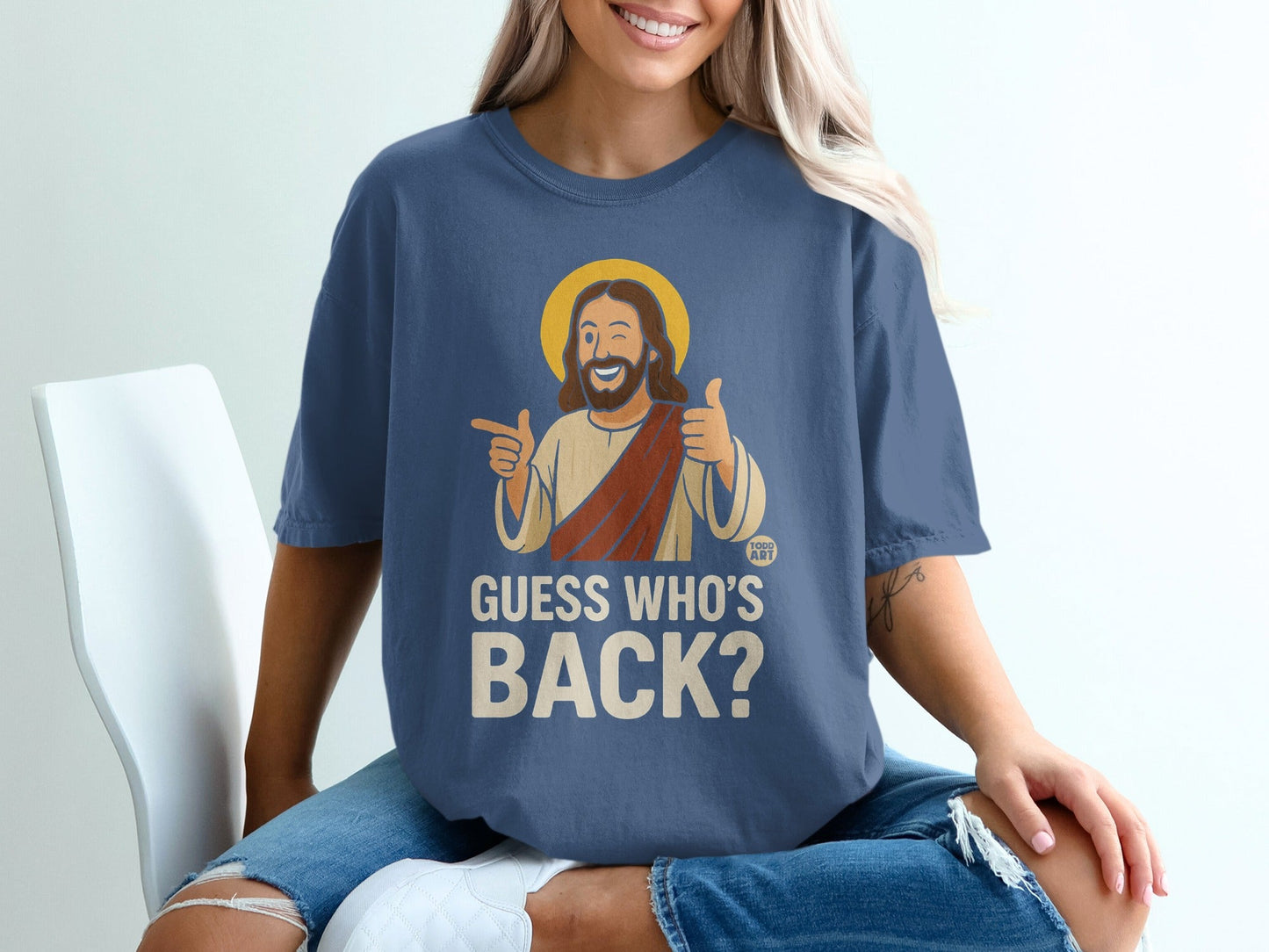 Jesus on blue t-shirt with text "GUESS WHO'S BACK?".