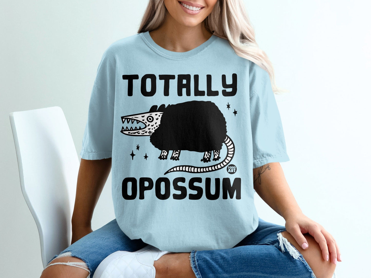 Light blue t-shirt with "TOTALLY OPOSSUM" and a cartoon opossum graphic.