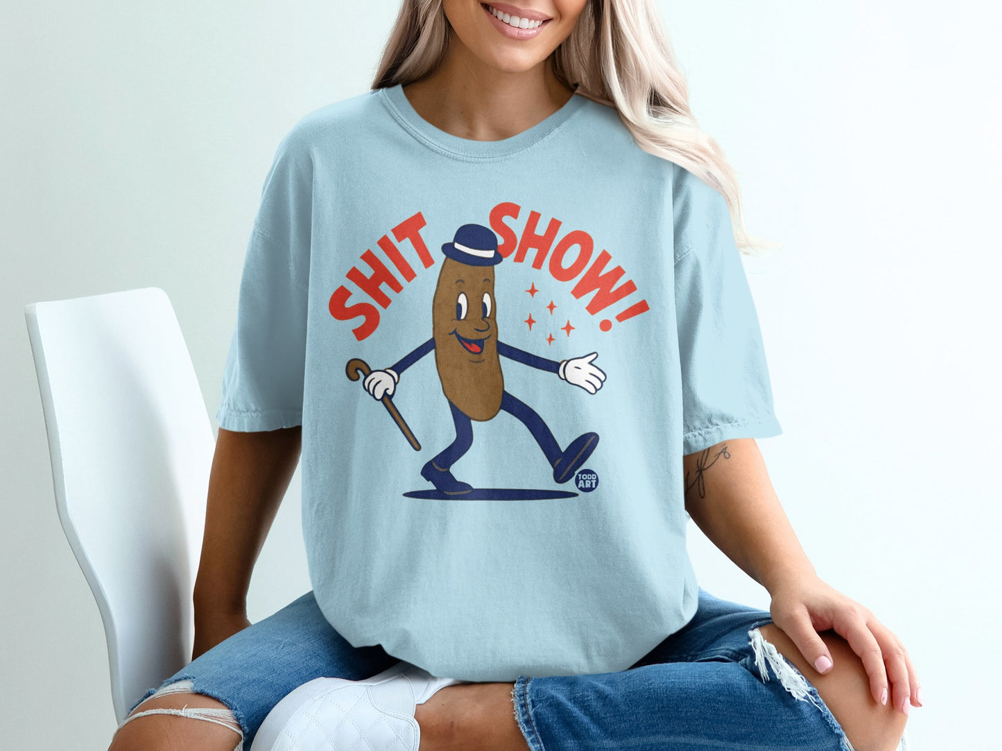 Cartoon brown figure in hat and suit, holding cane, with "SHIT SHOW!" text.