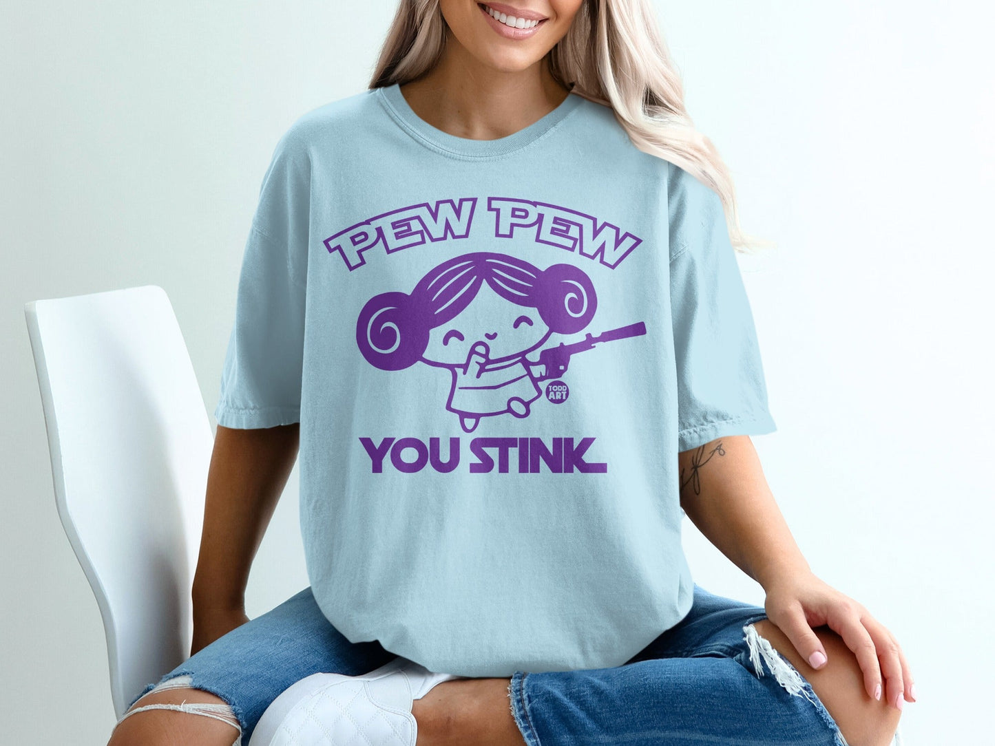 Light blue t-shirt with "Pew Pew You Stink" graphic of a girl holding a toy gun.