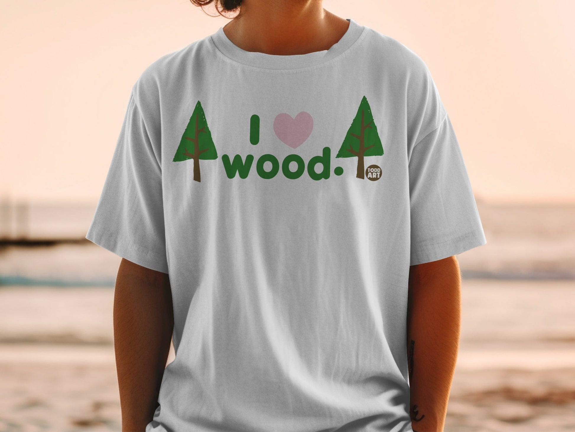White t-shirt with "I ‚ù§Ô∏è wood." graphic and two trees.