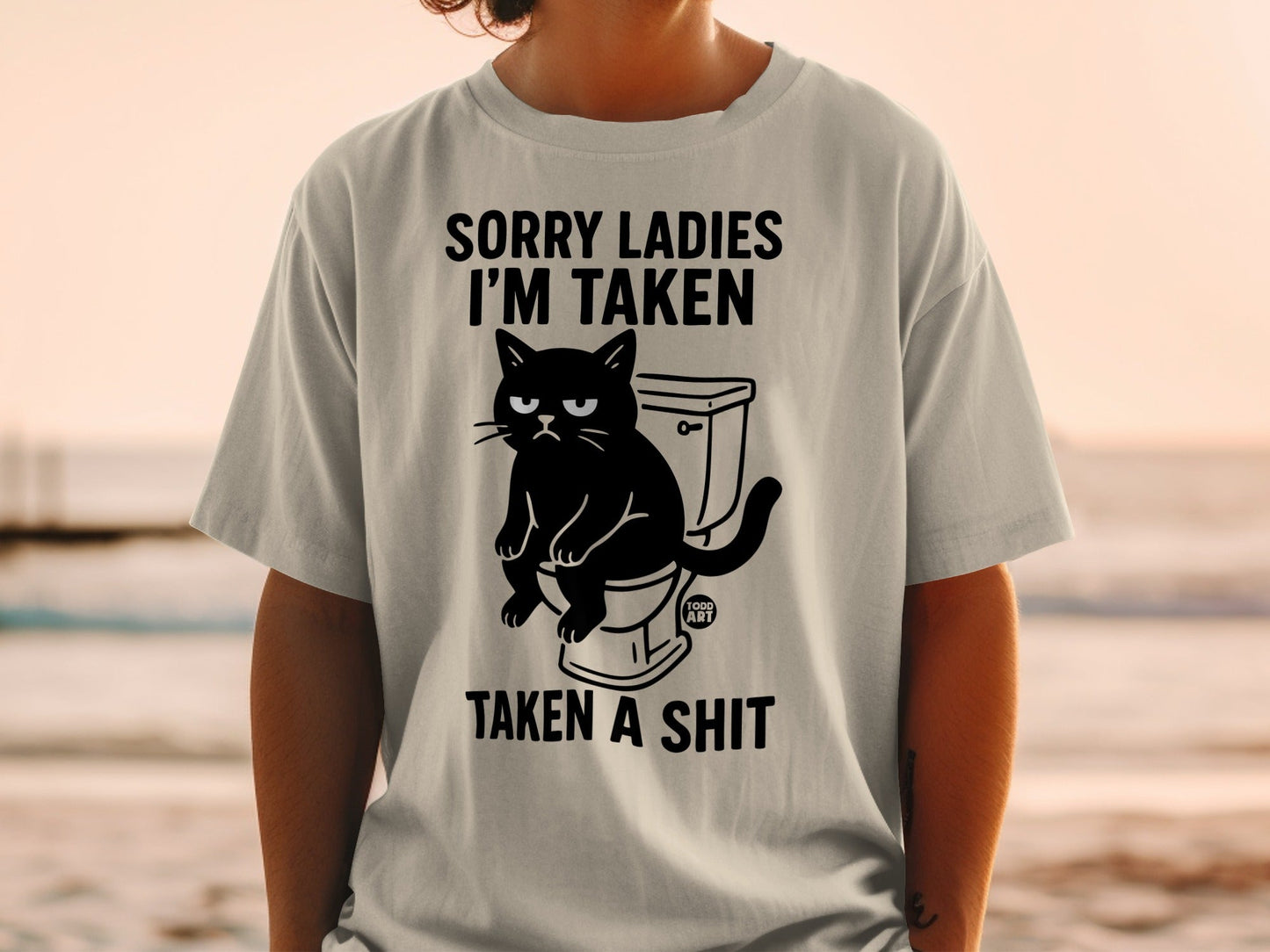 Black cat sitting on a toilet with text "SORRY LADIES I'M TAKEN TAKEN A SHIT".