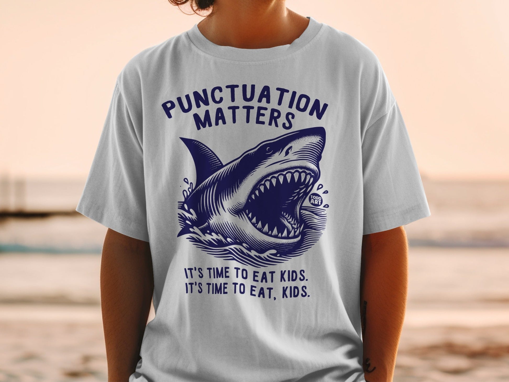T-shirt with shark graphic and "Punctuation Matters" text.