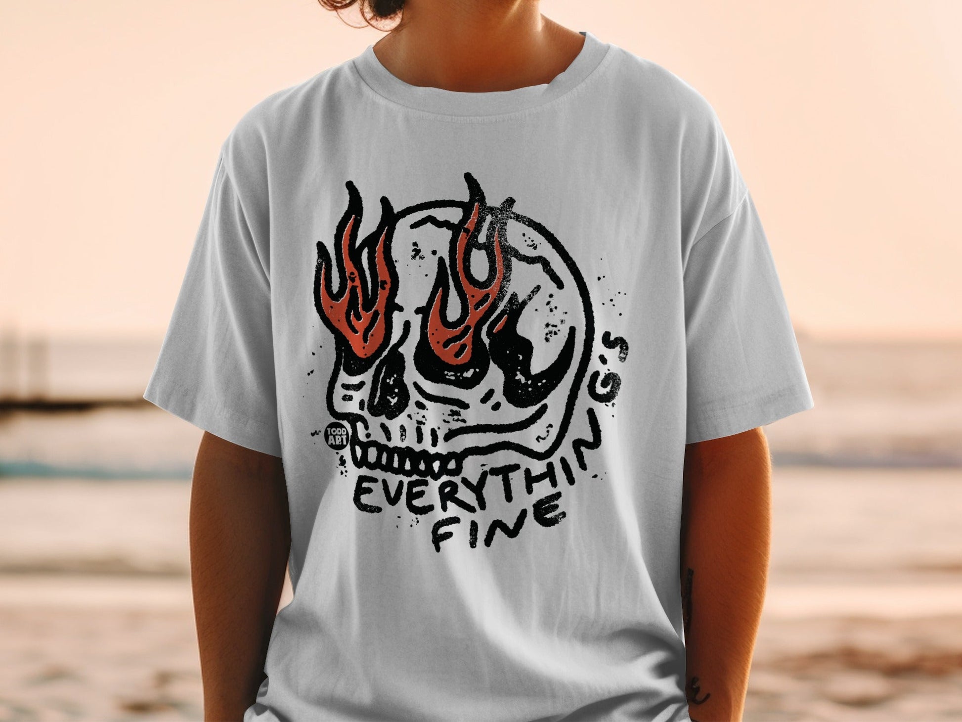 Skull with flames and "Everything Fine" text on a white t-shirt.