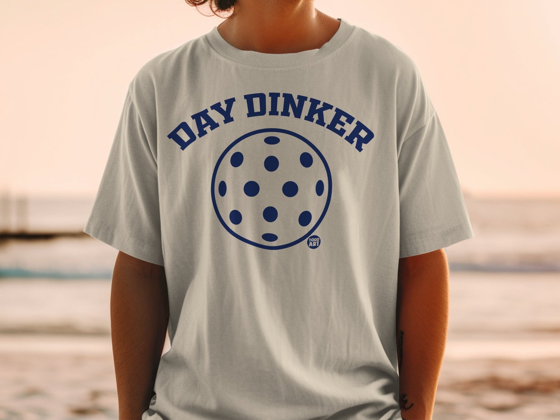 Gray t-shirt with "DAY DINKER" and pickleball graphic.