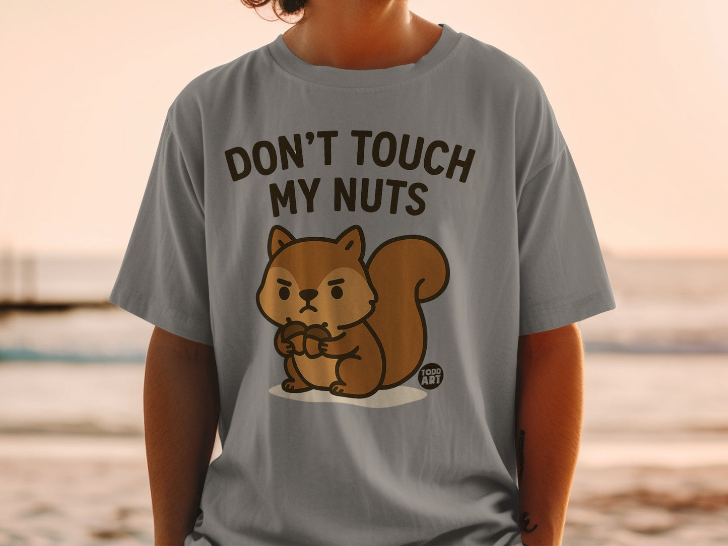 Gray t-shirt with a cartoon squirrel holding acorns and text "Don't Touch My Nuts".