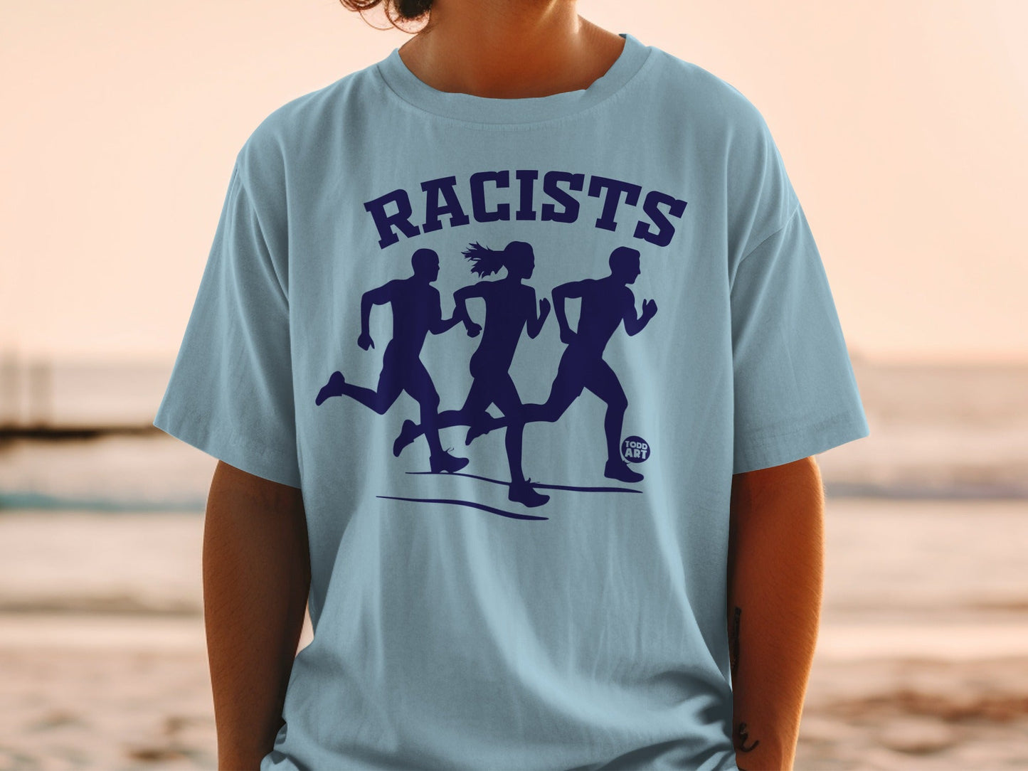 Light blue t-shirt with graphic of three running figures and text "RACISTS"