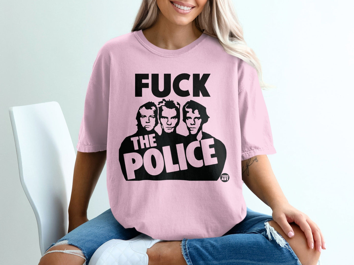 Pink t-shirt with "FUCK THE POLICE" graphic featuring three men.