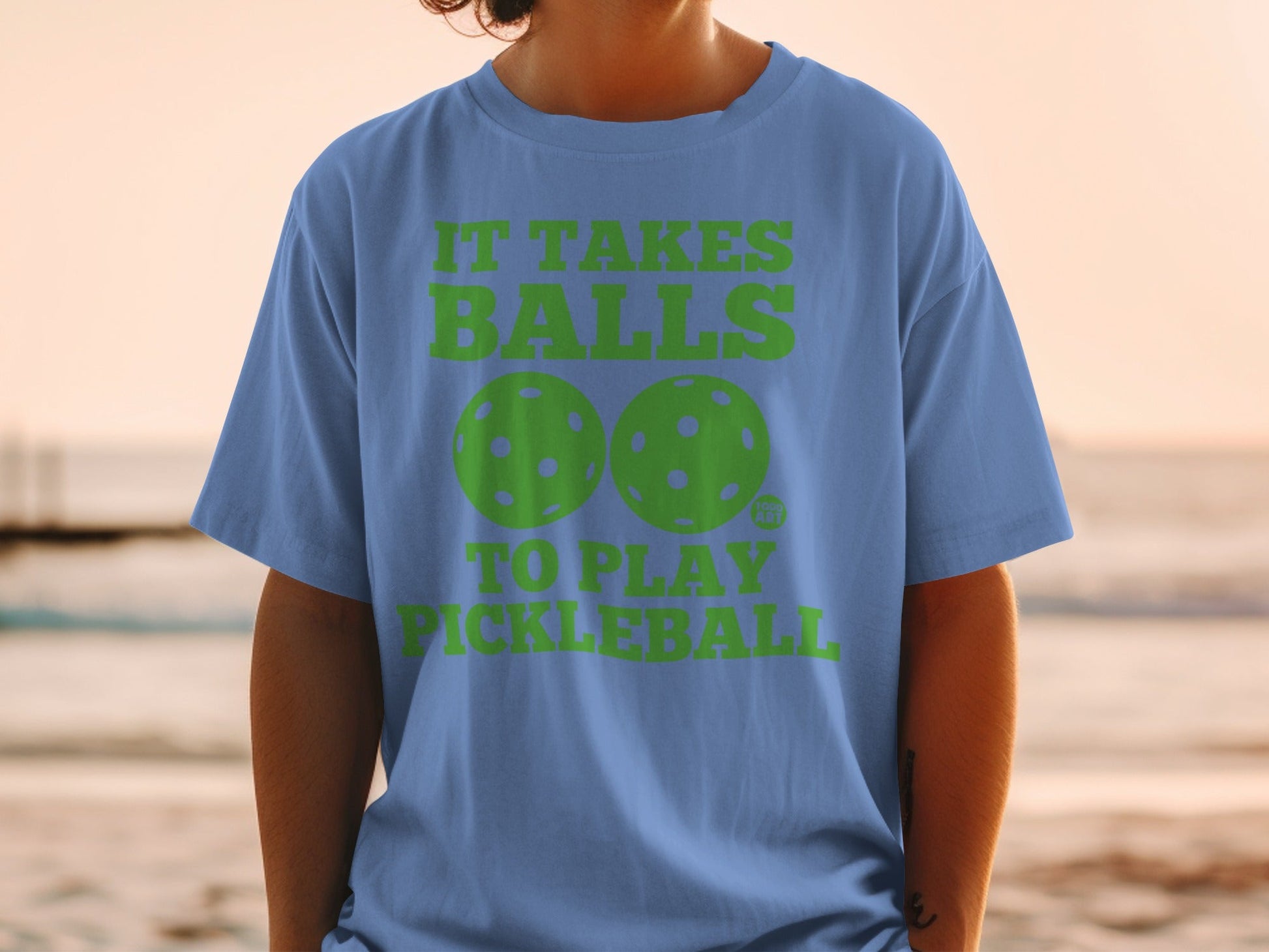 Blue t-shirt with "IT TAKES BALLS TO PLAY PICKLEBALL" and pickleball graphic.