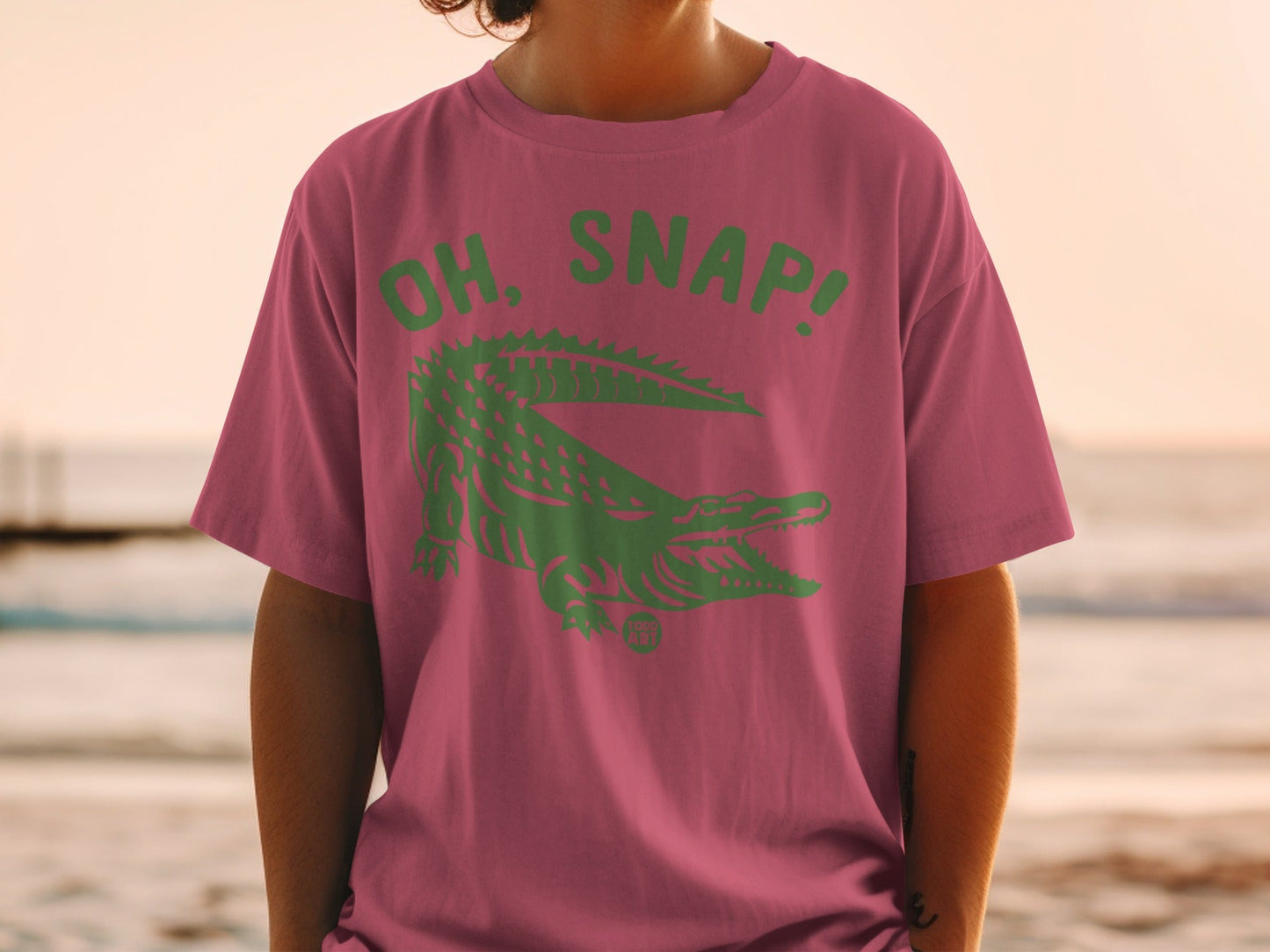 Pink t-shirt with green alligator and "OH, SNAP!" text.