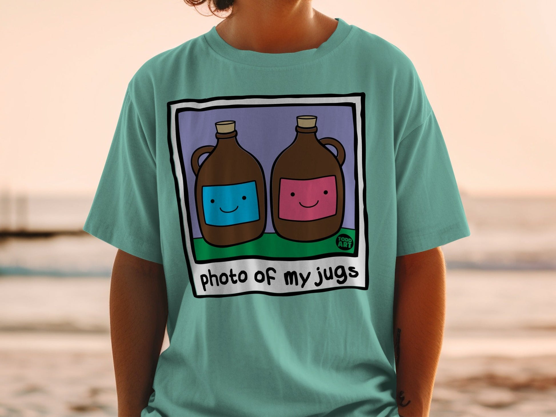 Teal t-shirt with cartoon jugs, one blue, one pink, text "photo of my jugs".