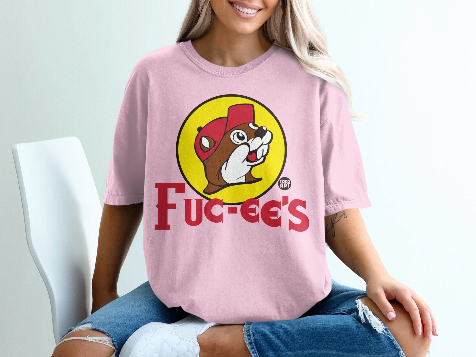 Pink t-shirt with Bucee's beaver logo and text "Bucee's 100%".