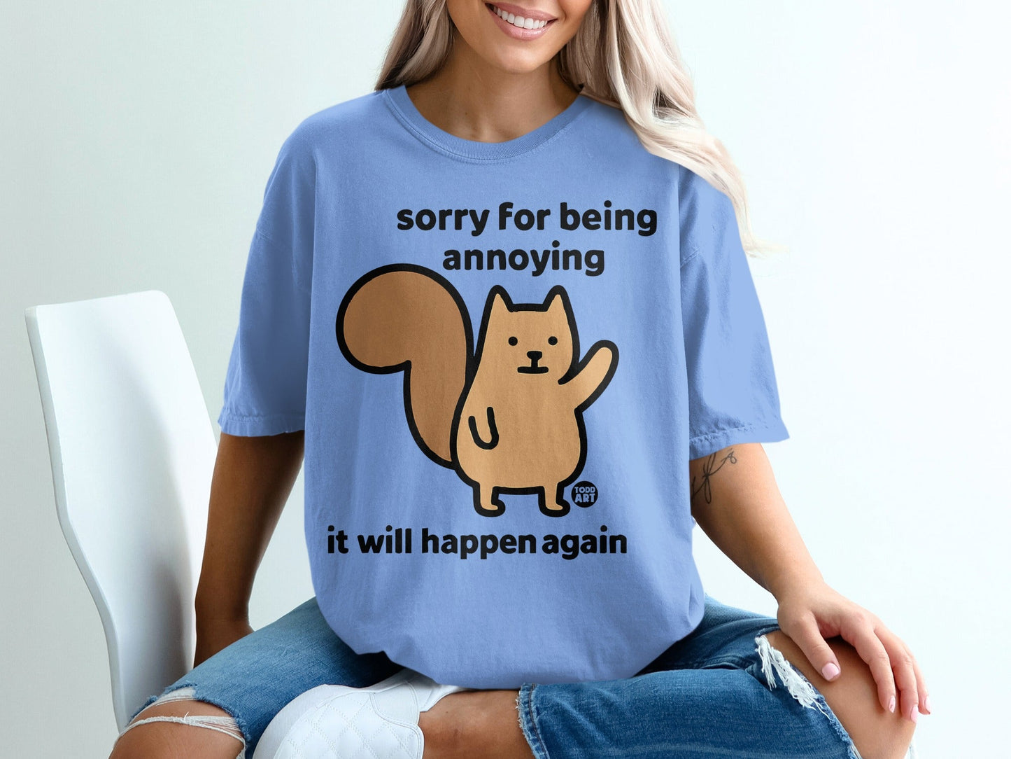 Blue t-shirt with a cartoon squirrel graphic and text "sorry for being annoying it will happen again".