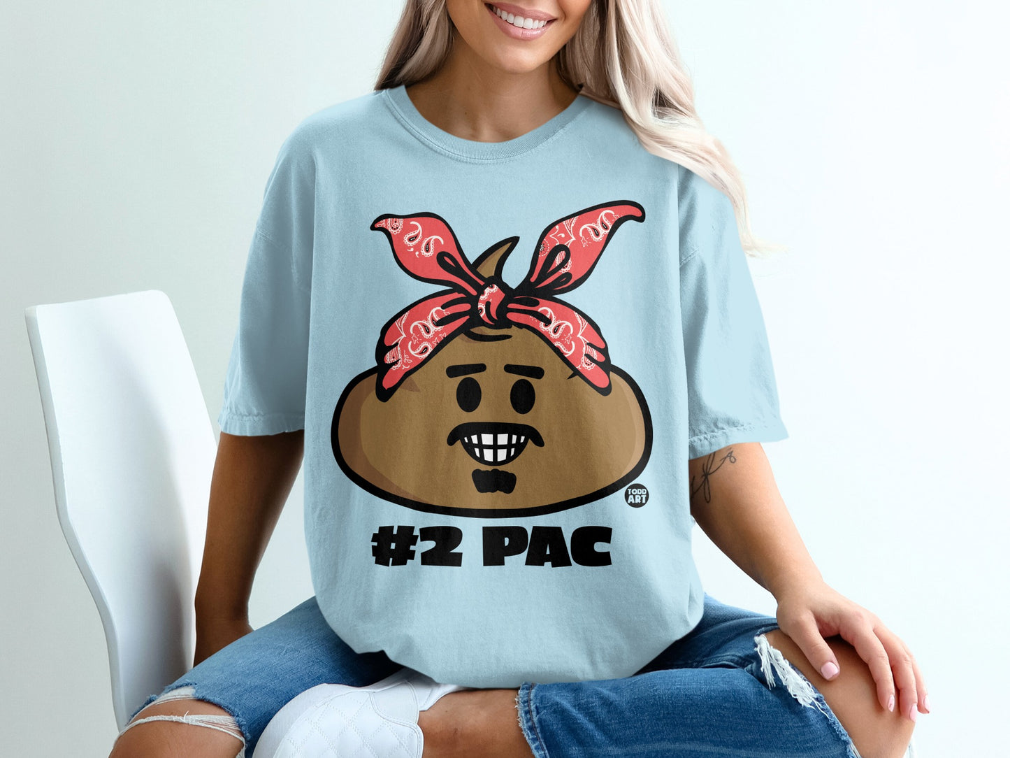 Light blue t-shirt with a cartoon character wearing a red bandana and "#2 PAC" text.