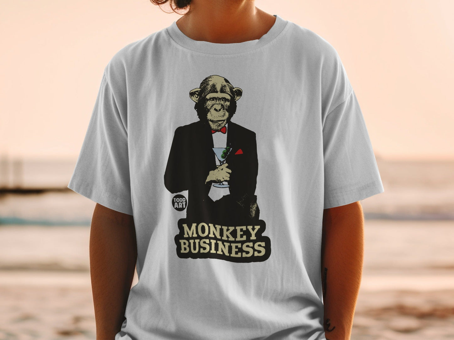 T-shirt with a monkey in a tuxedo holding a martini glass, text "MONKEY BUSINESS".