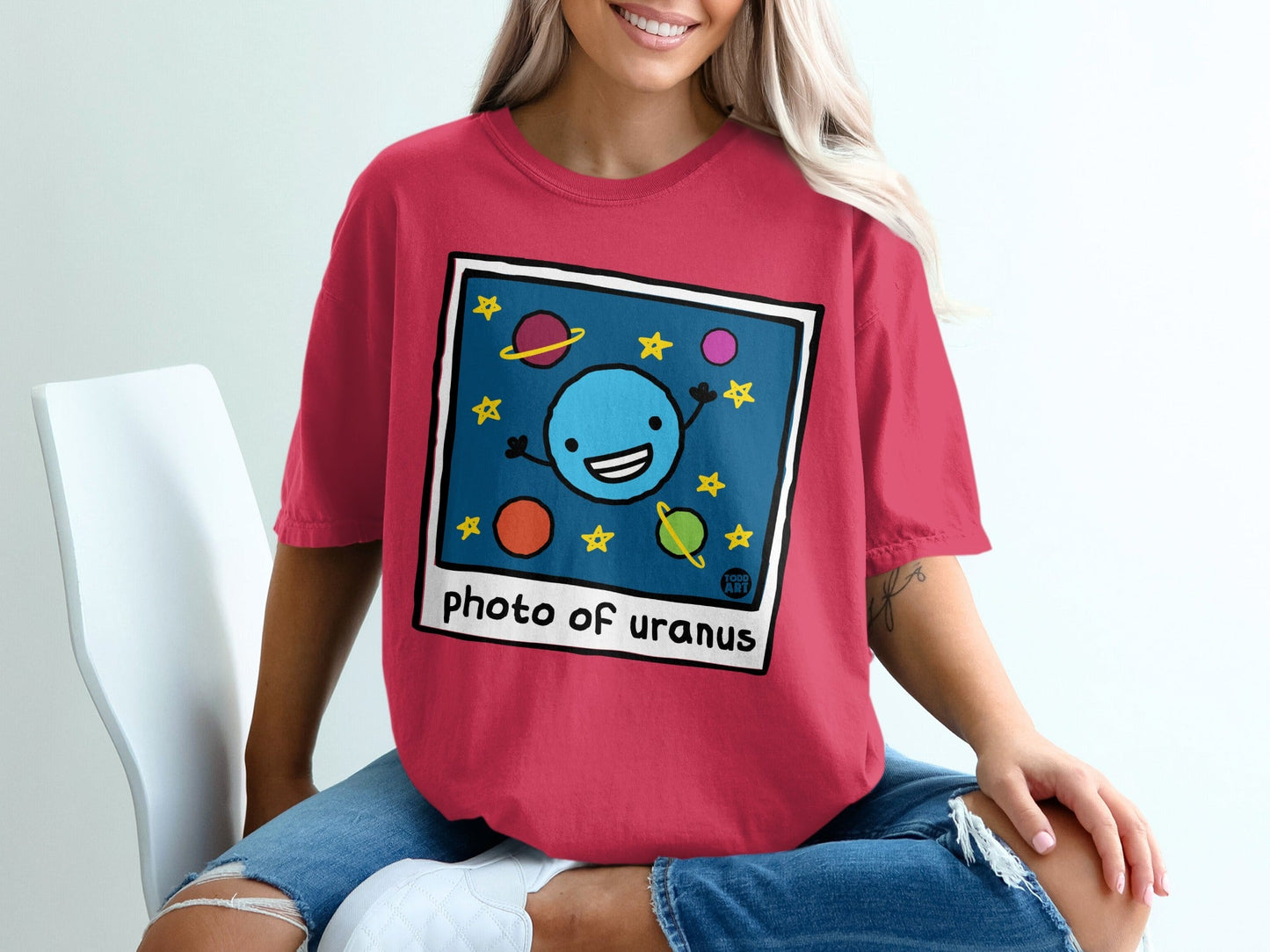 Pink t-shirt with "photo of uranus" text and cartoon planets.