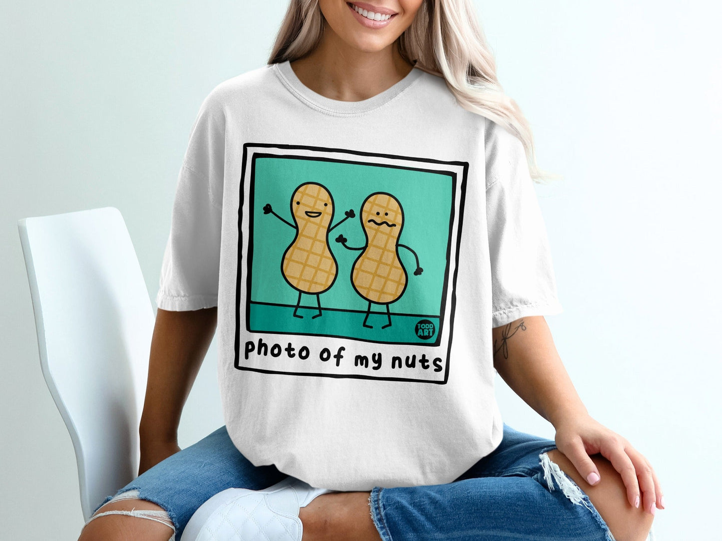 T-shirt with illustration of two cartoon peanuts saying "photo of my nuts".