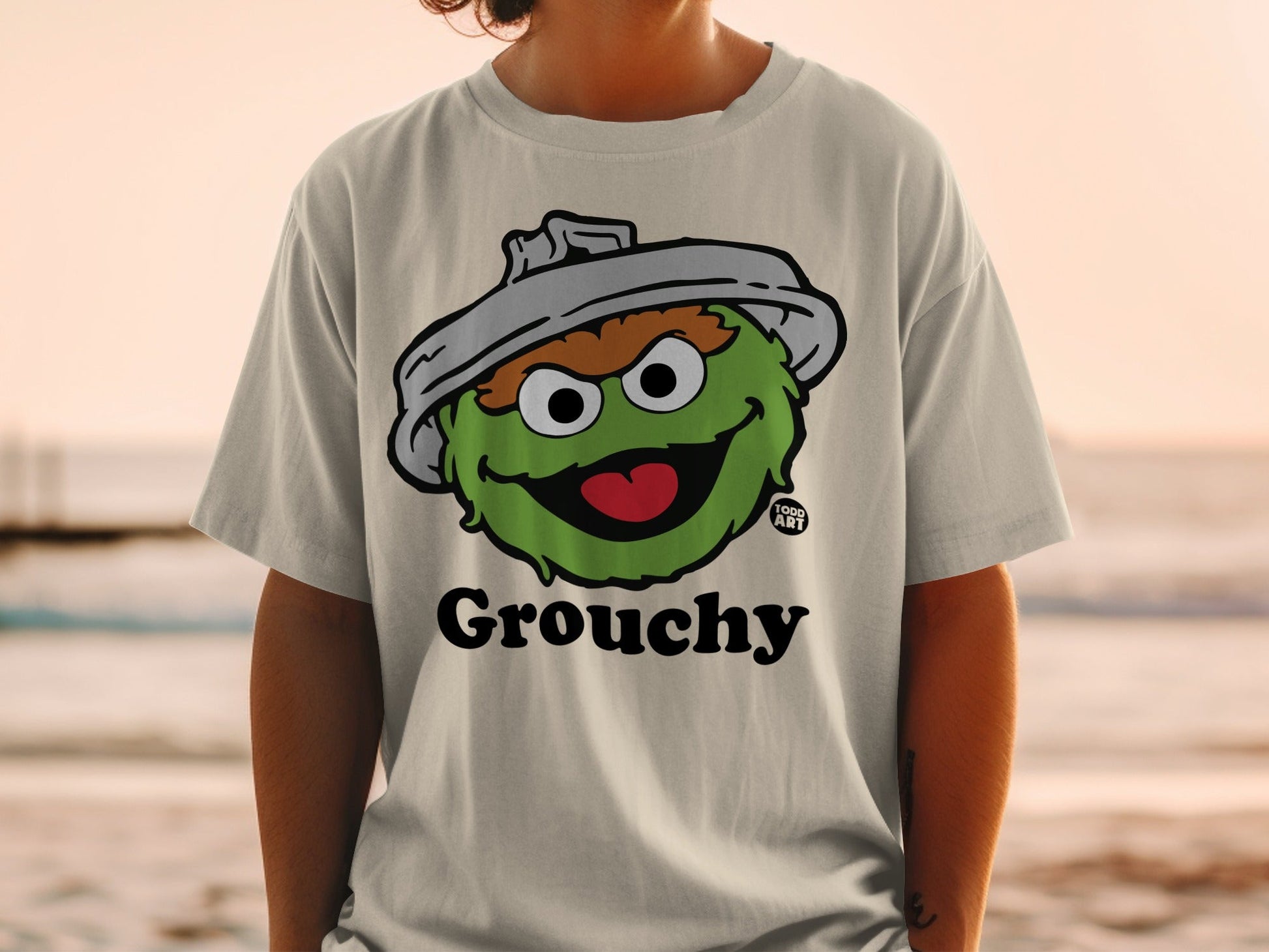 Light gray t-shirt with Grouchy from Sesame Street graphic.