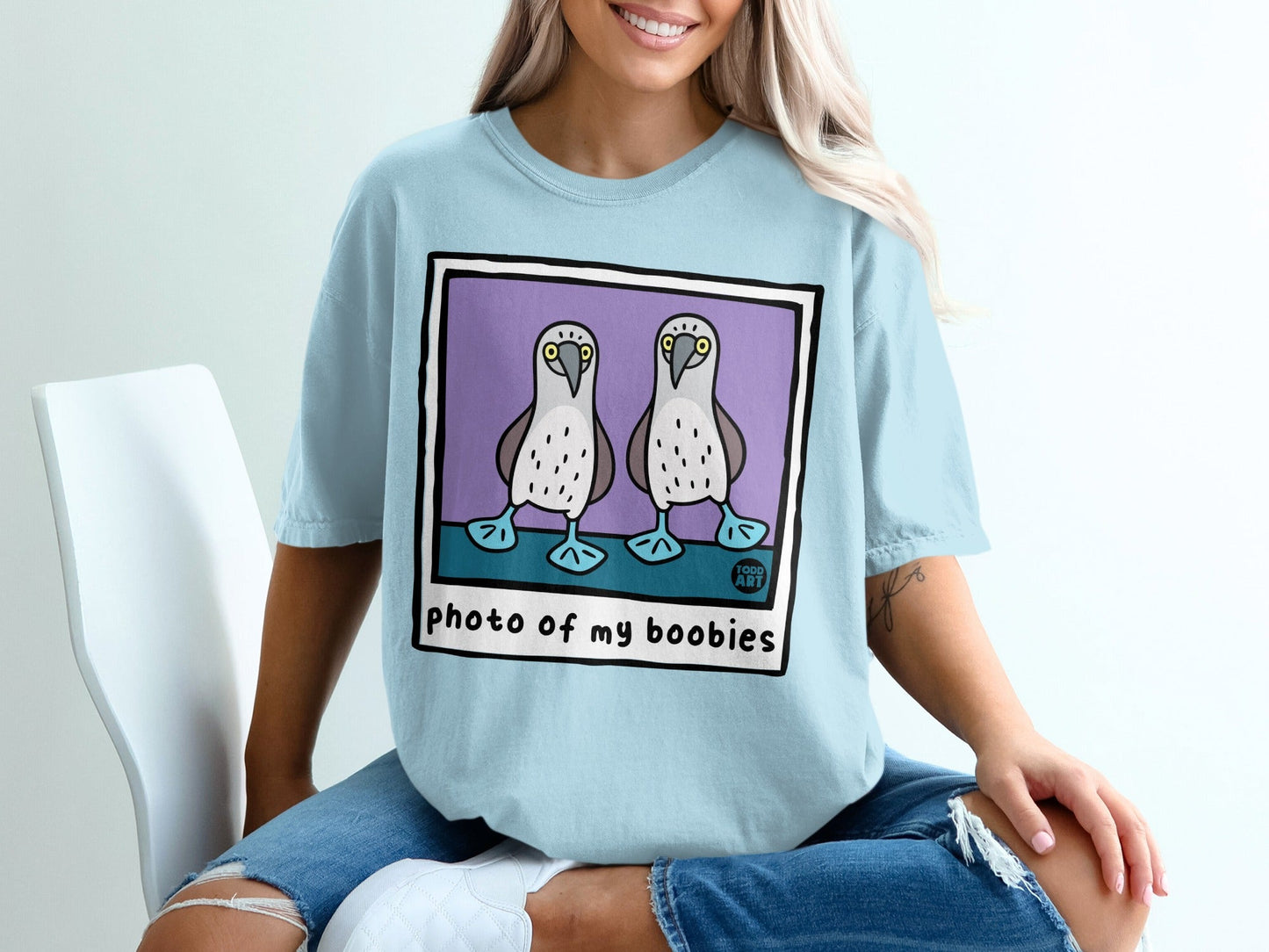 Light blue t-shirt with cartoon boobies and "photo of my boobies" text.