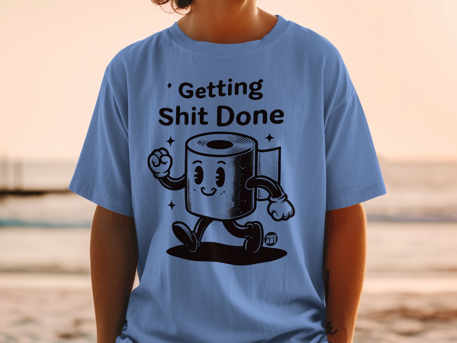 Blue t-shirt with cartoon toilet paper roll "Getting Shit Done" graphic.