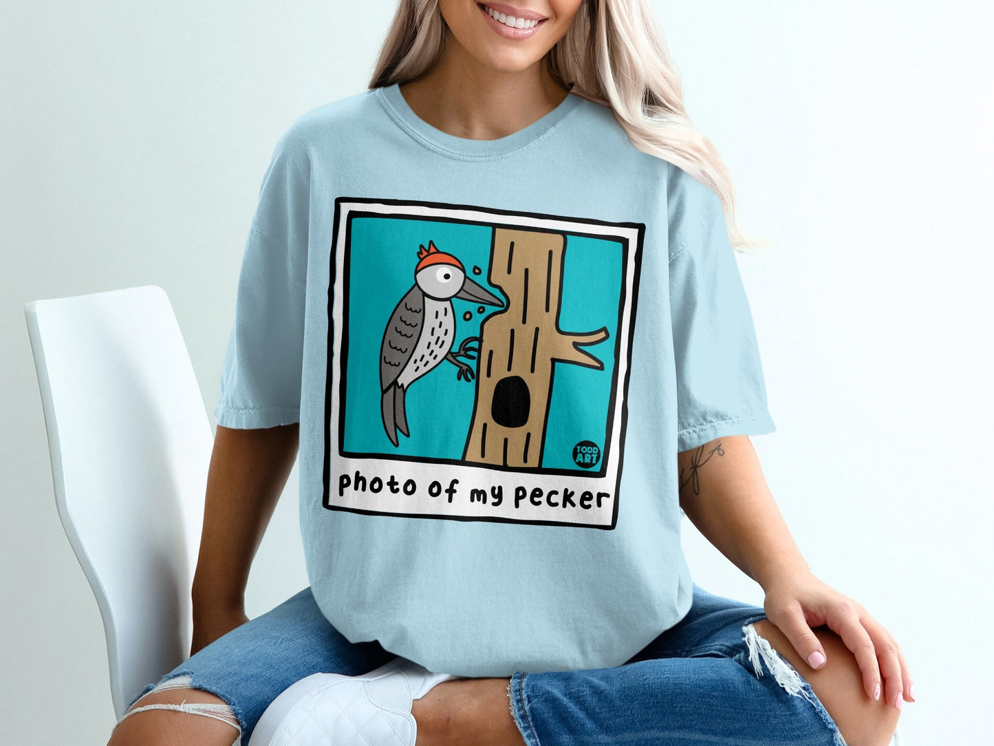 Light blue t-shirt with "photo of my pecker" and a cartoon woodpecker on a tree.