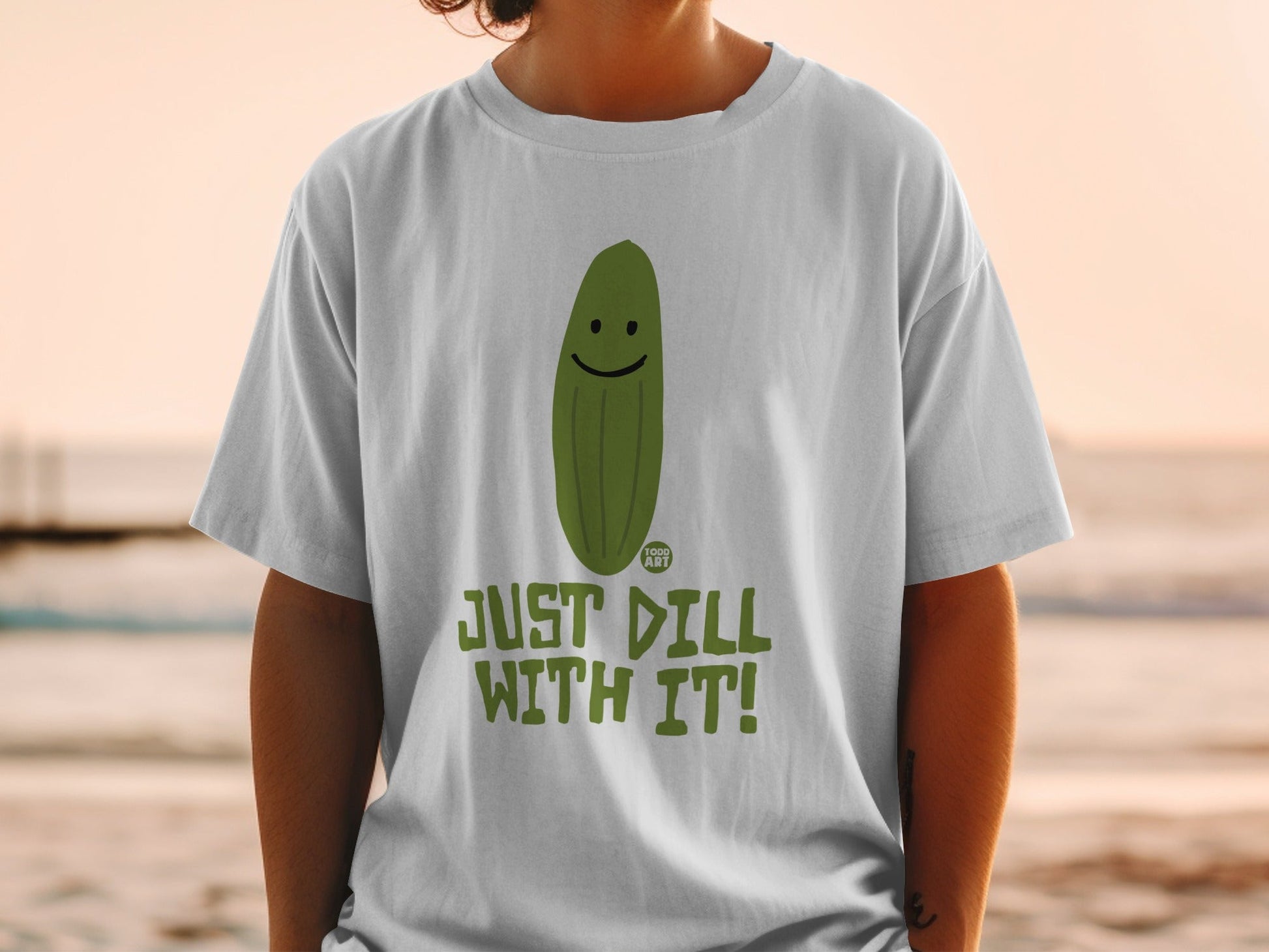 T-shirt with a smiling pickle and "JUST DILL WITH IT!" text.