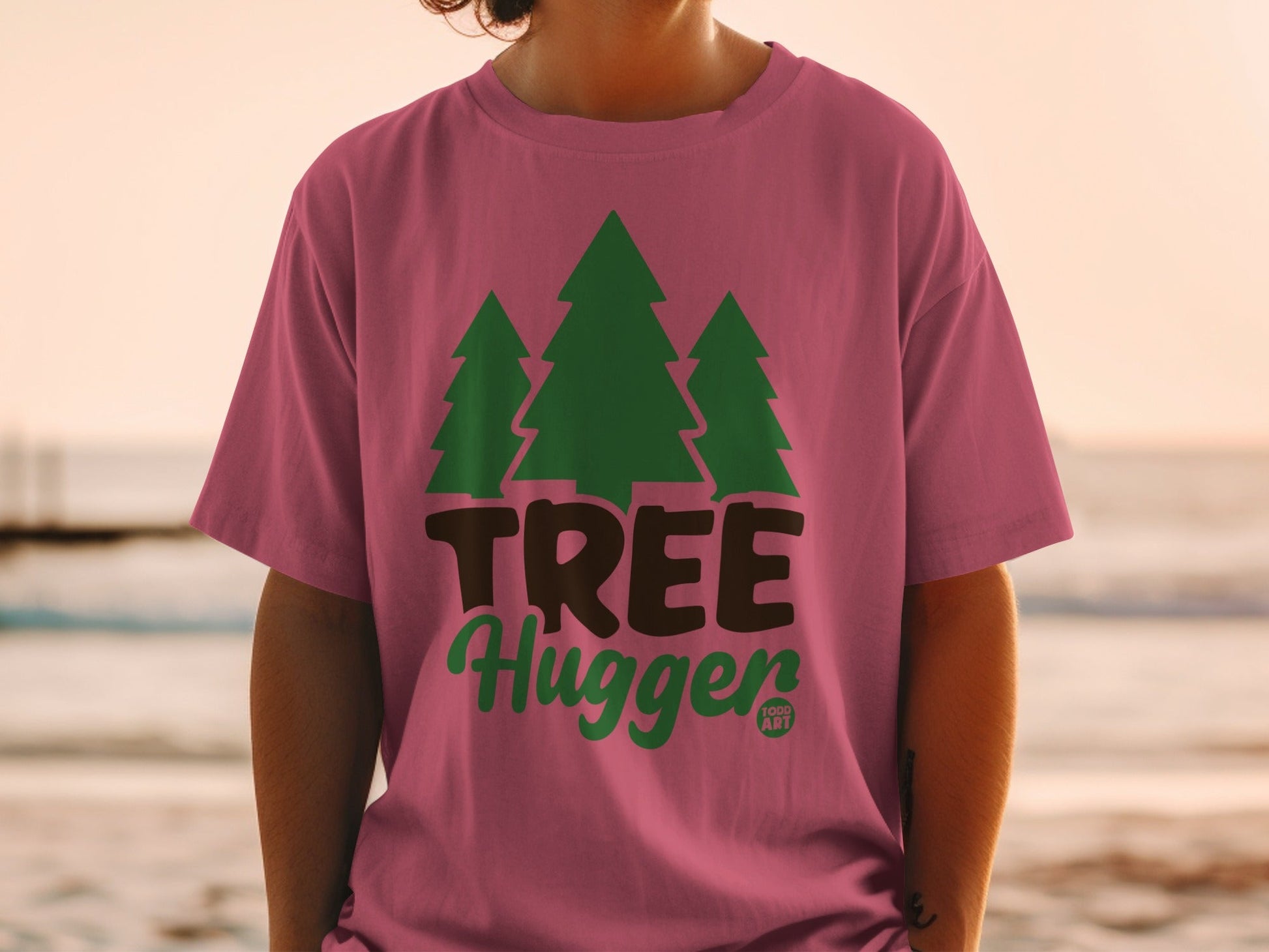 Pink t-shirt with "TREE Hugger" text and three green trees graphic.