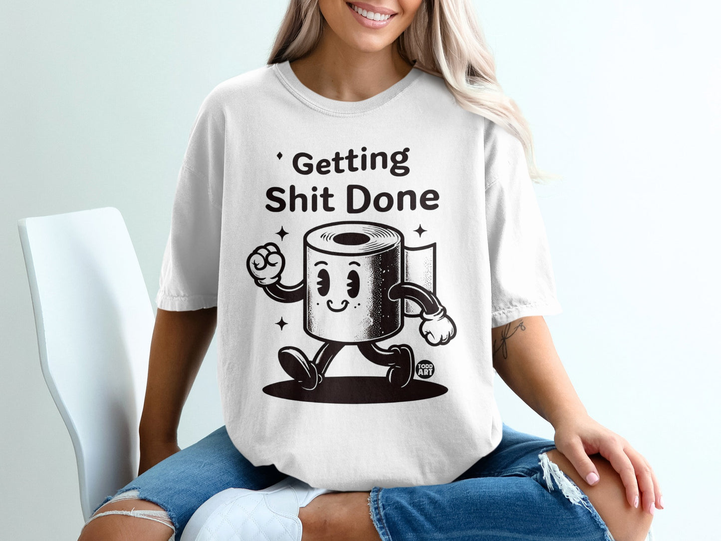 White t-shirt with cartoon toilet paper roll saying "Getting Shit Done".