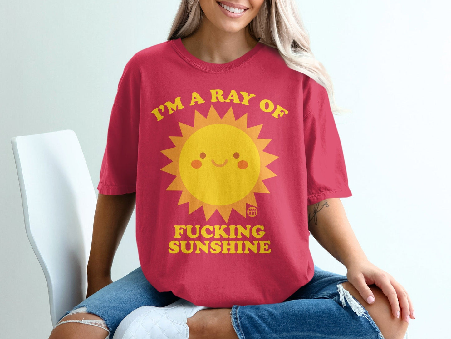 Red t-shirt with a smiling sun graphic and "I'M A RAY OF FUCKING SUNSHINE" text.