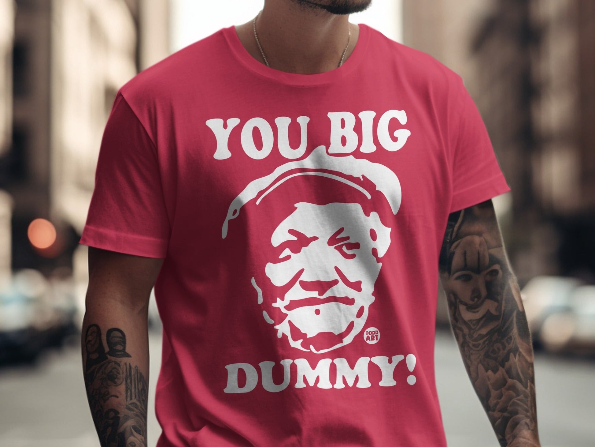 Red t-shirt with white graphic of a man's face and "YOU BIG DUMMY!" text.