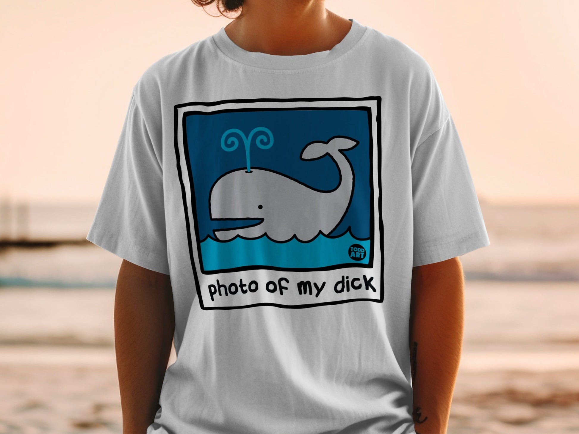 White t-shirt with cartoon whale graphic and "photo of my dick" text.