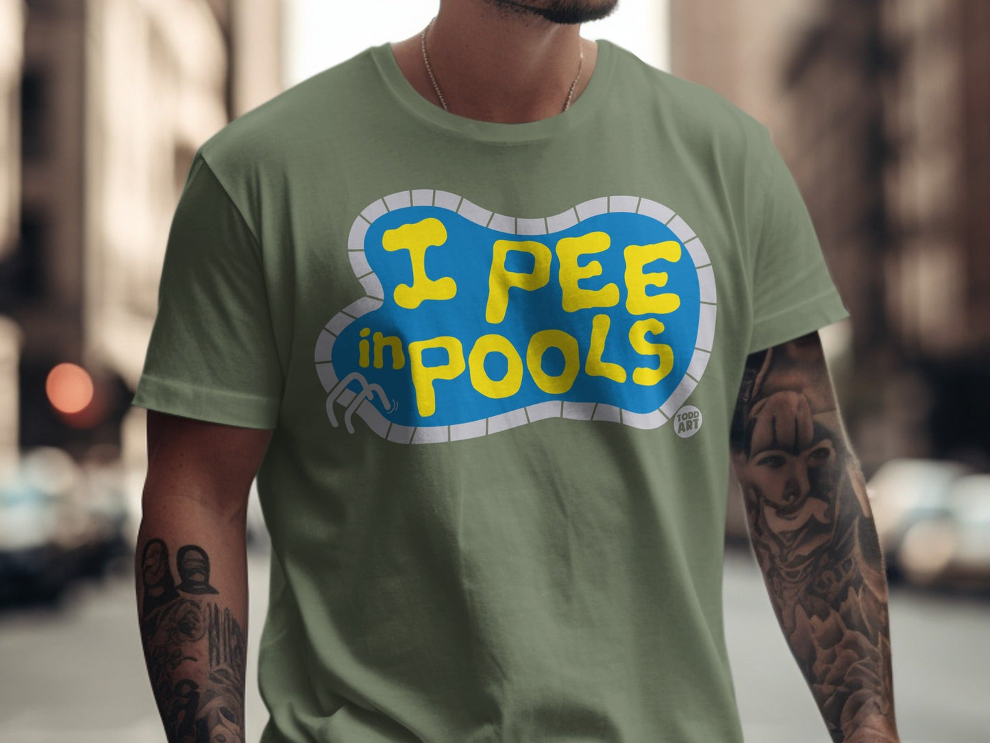 Green t-shirt with yellow text reading "I PEE IN POOLS" inside a blue pool outline.