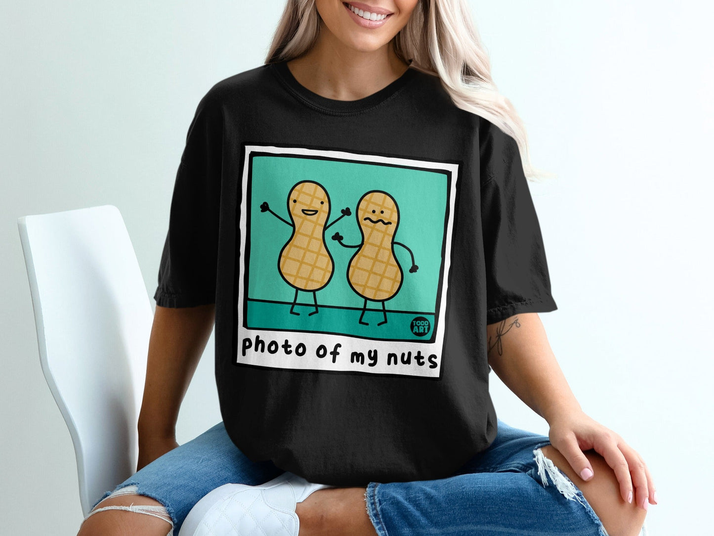 Black t-shirt with cartoon peanuts saying "Photo of my nuts".