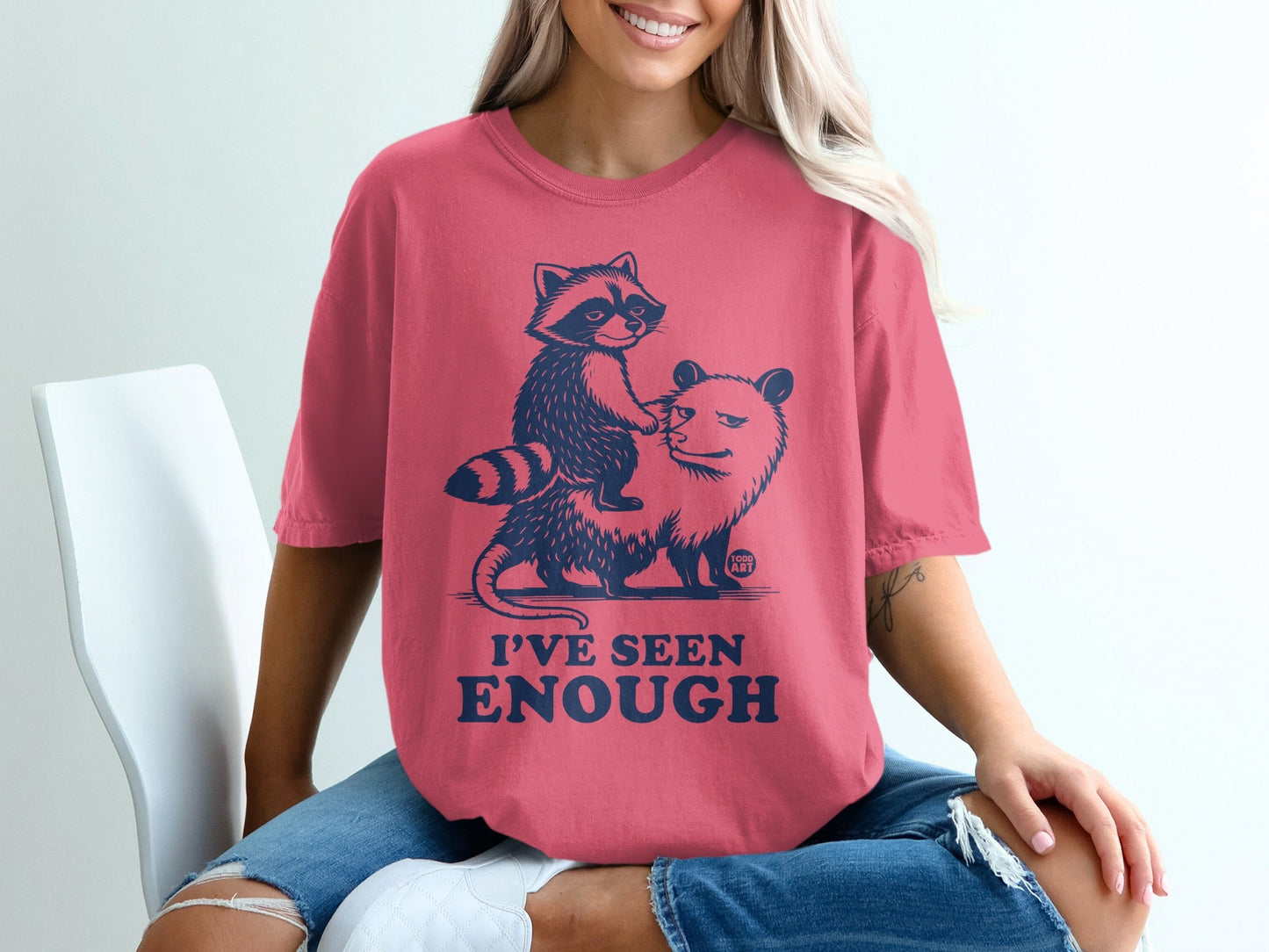 Pink t-shirt with raccoon riding opossum and text "I'VE SEEN ENOUGH".