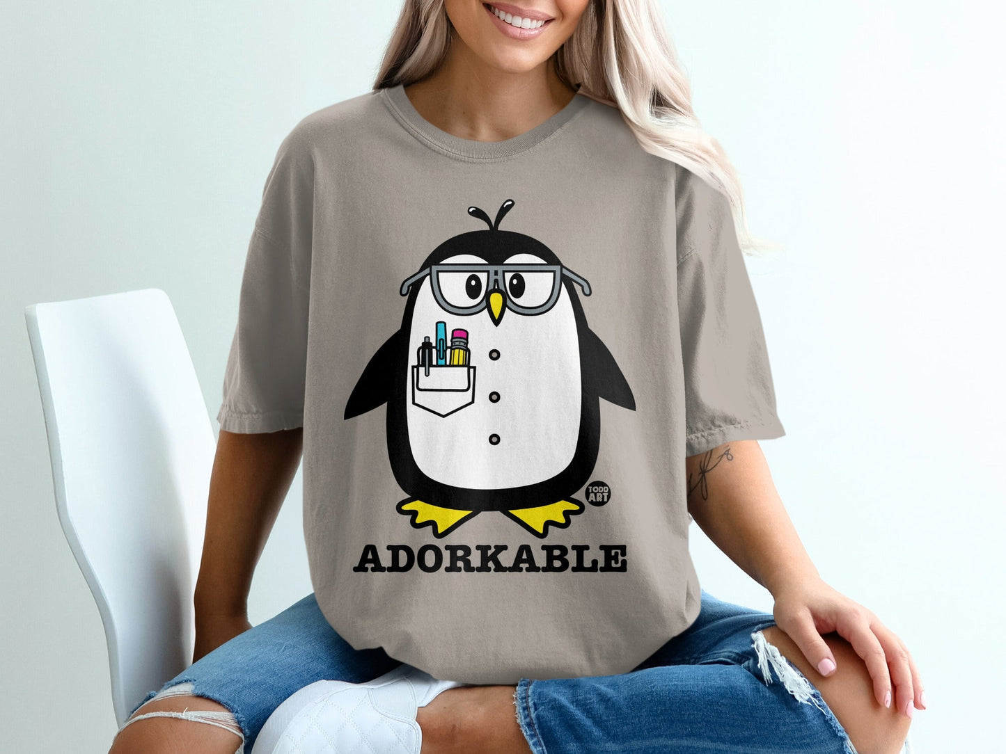 Penguin wearing glasses and holding pens in its chest pocket, "Adorkable" text below.