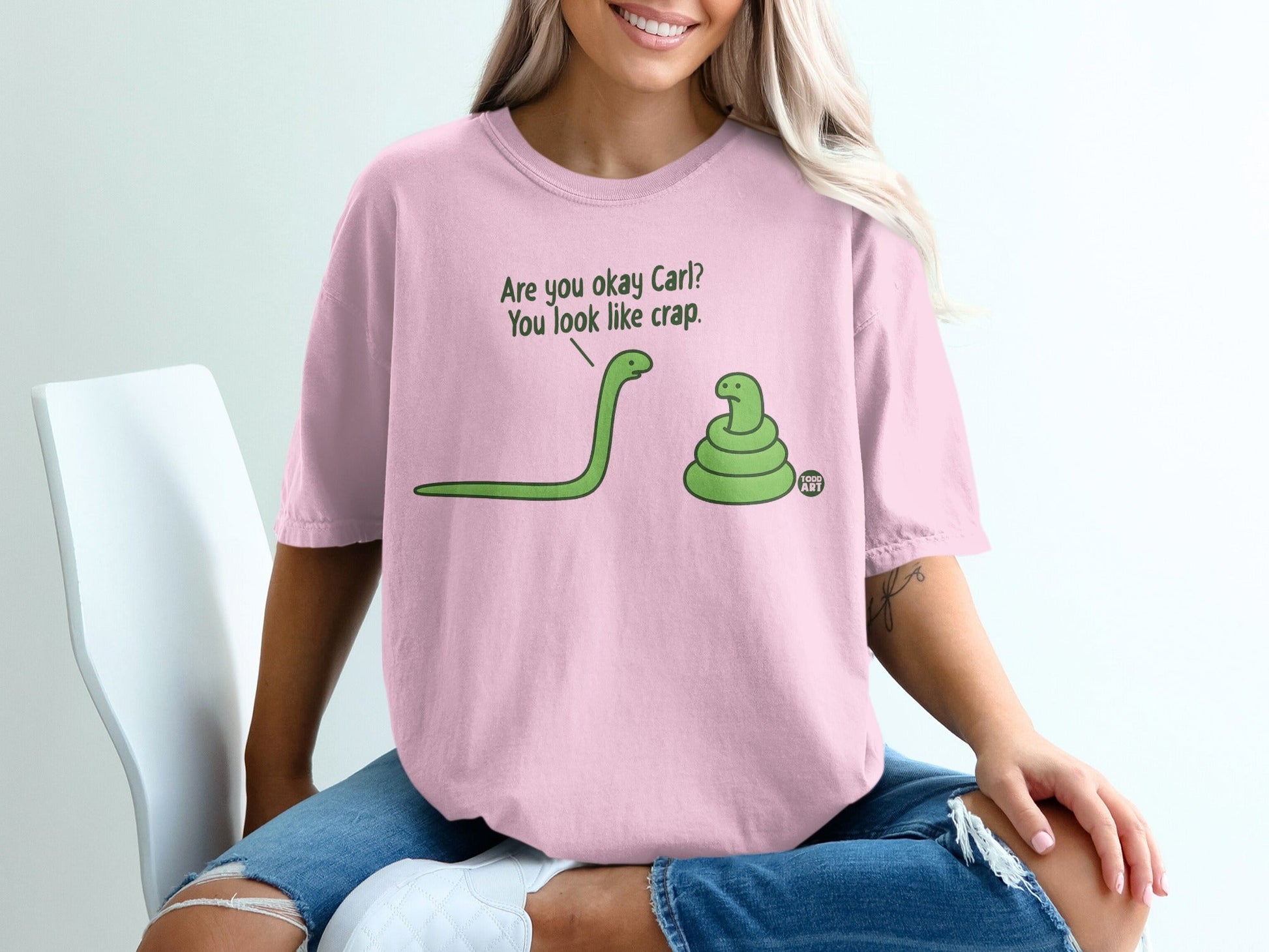 Pink t-shirt with cartoon snakes asking "Are you okay Carl? You look like crap."