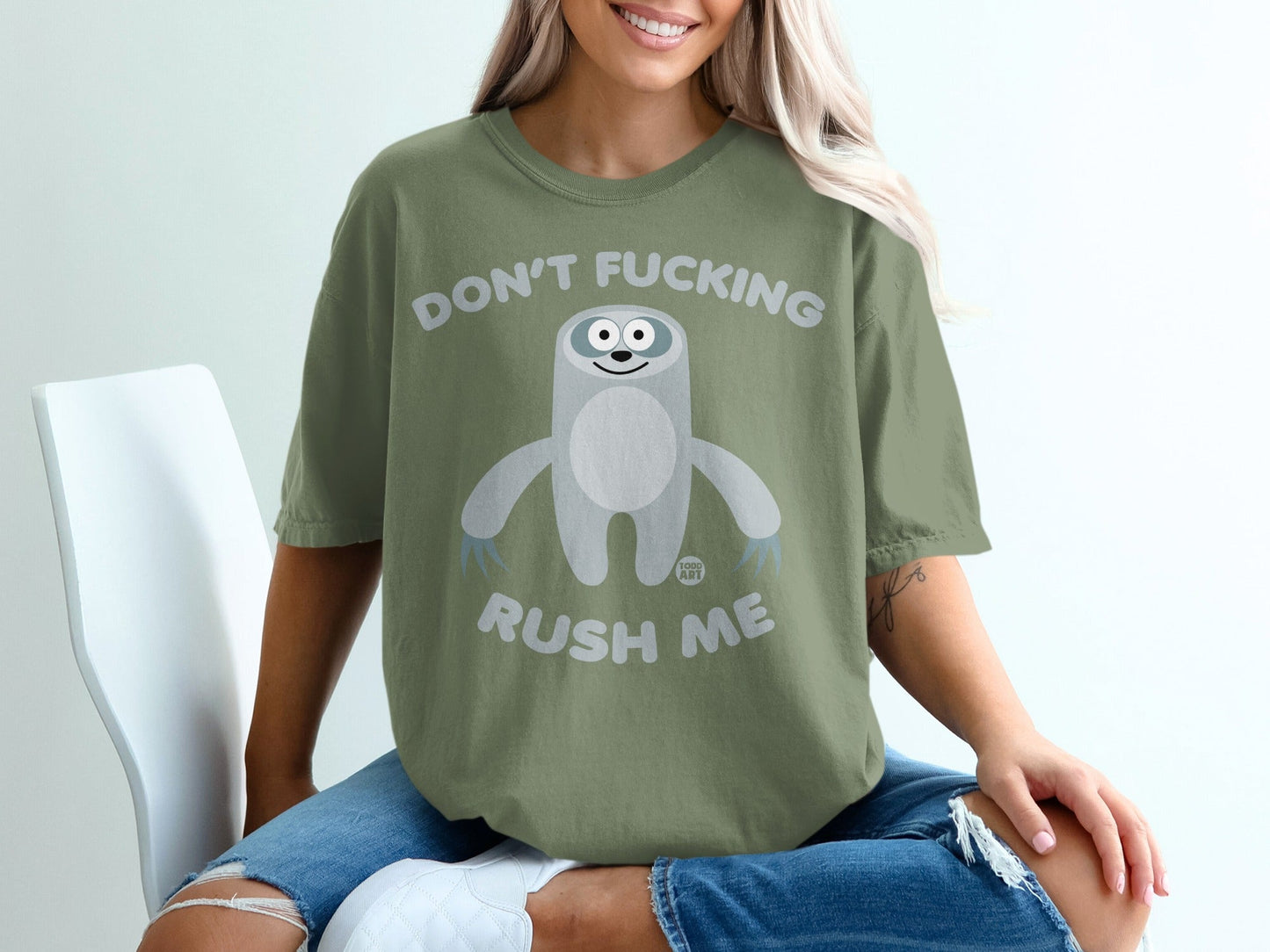 Green t-shirt with a sloth graphic and text "DON'T FUCKING RUSH ME".
