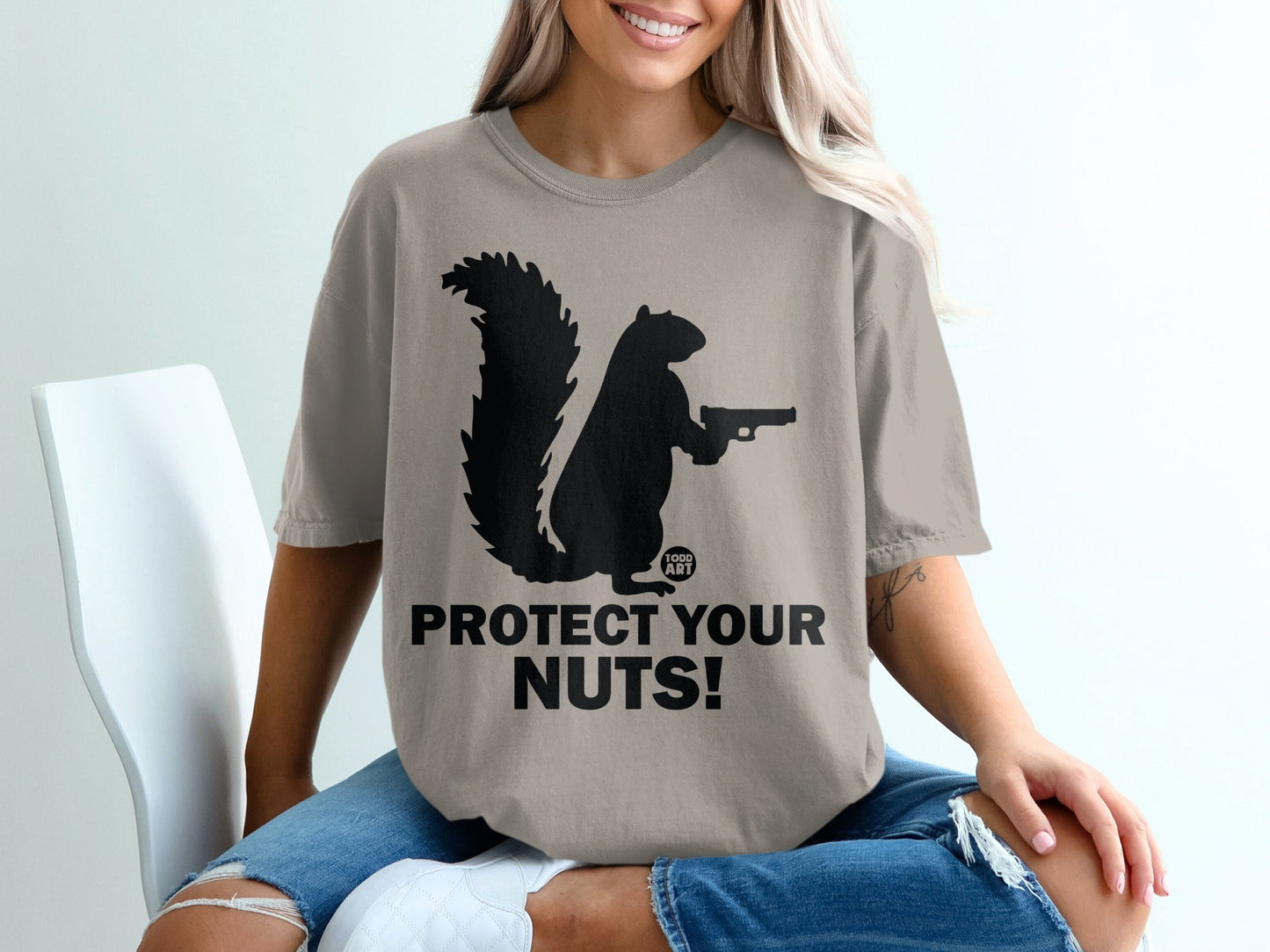 Silhouette of a squirrel holding a gun, text reads "PROTECT YOUR NUTS!".