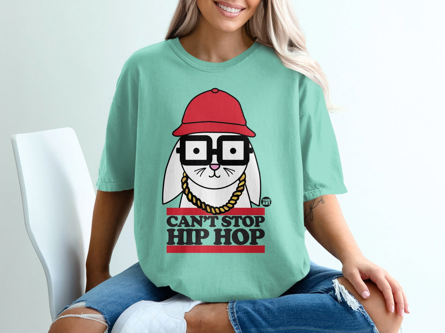 Mint t-shirt with a cartoon rabbit wearing glasses, hat, and gold chain, text "Can't Stop Hip Hop".