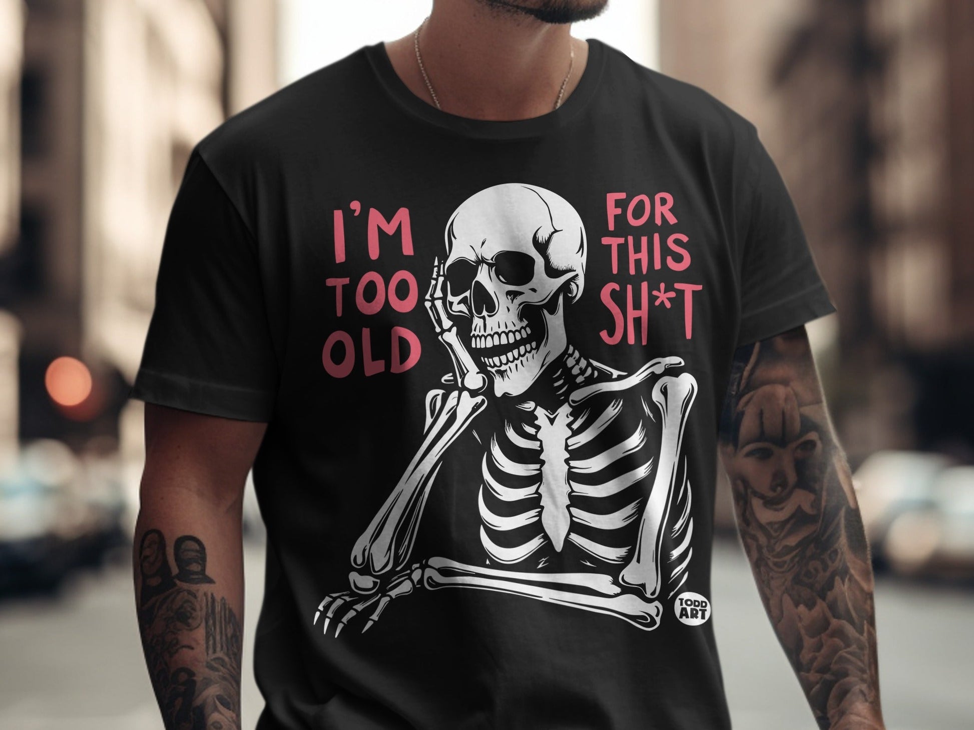 Black t-shirt with pink text "I'm TOO OLD FOR THIS SH*T" and a skeleton graphic.