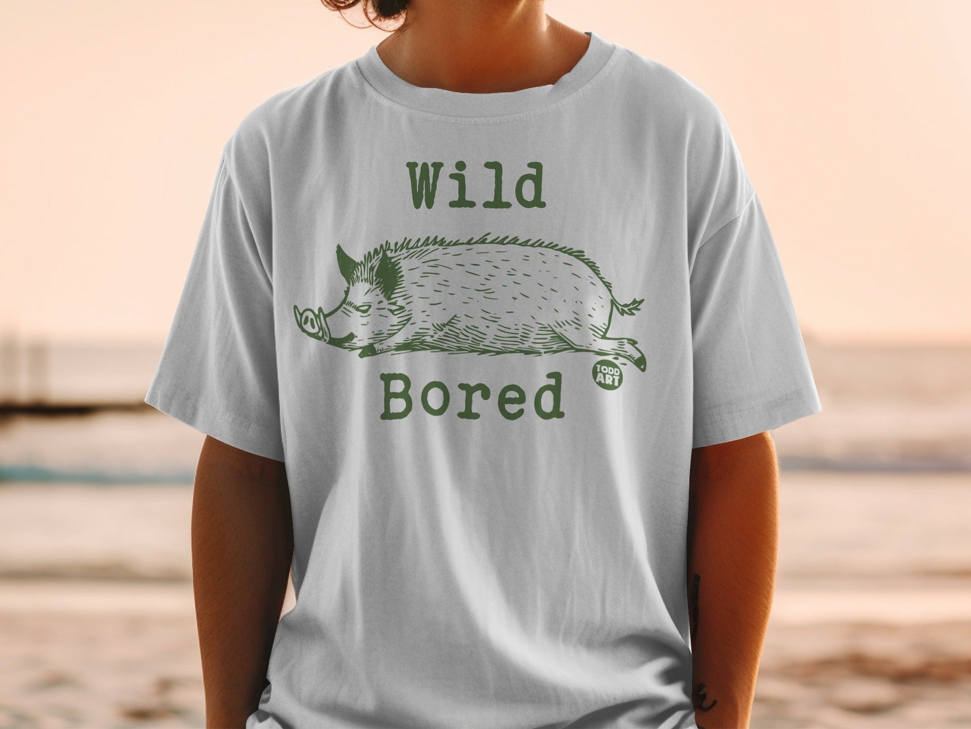T-shirt with green illustration of a wild boar and text "Wild Bored".