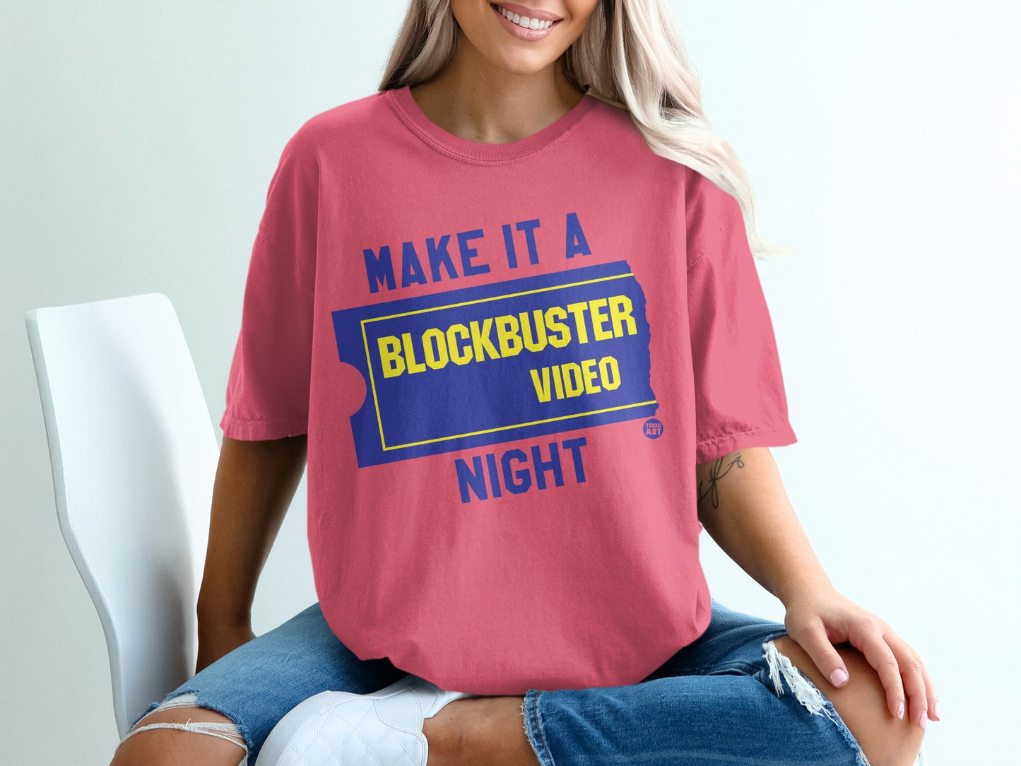 Pink t-shirt with "Make it a Blockbuster Night" text and ticket graphic.