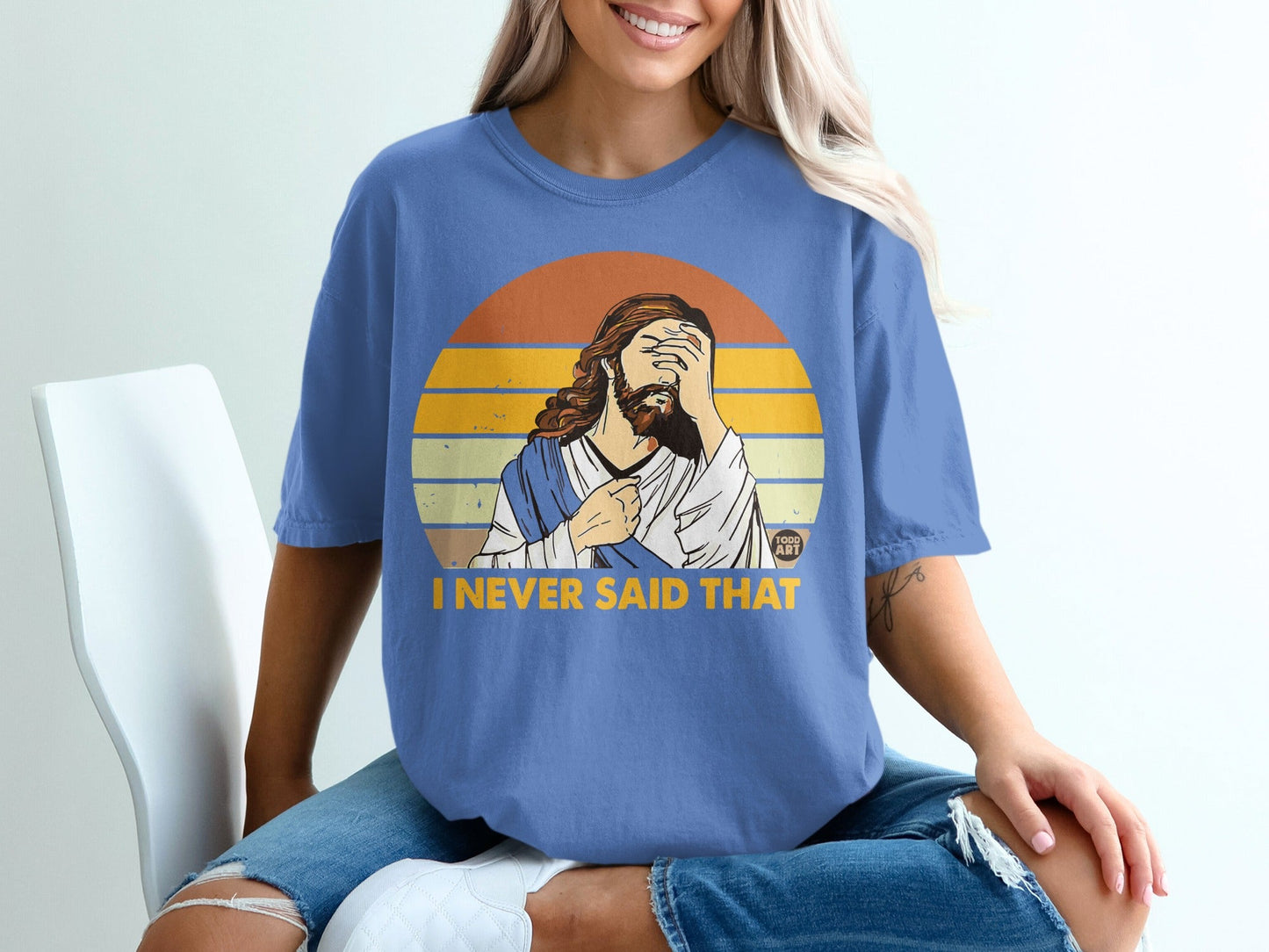 Jesus with hand over face on blue t-shirt with "I NEVER SAID THAT" text.