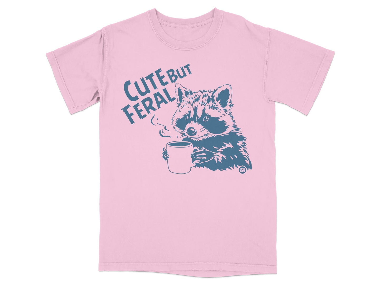 T-shirt with raccoon holding coffee cup and text "Cute But Feral".