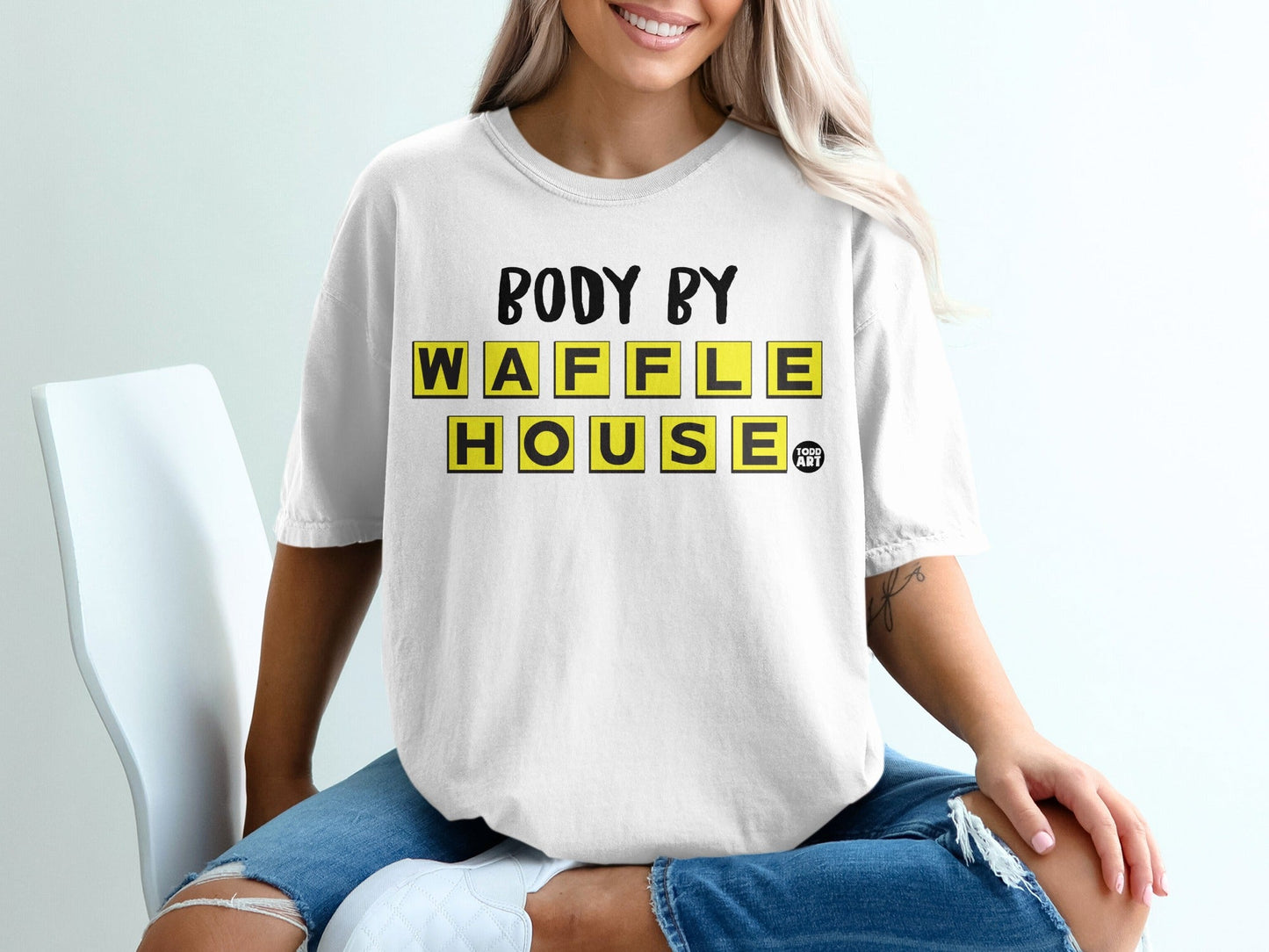 White t-shirt with "BODY BY WAFFLE HOUSE FOOD ART" text.
