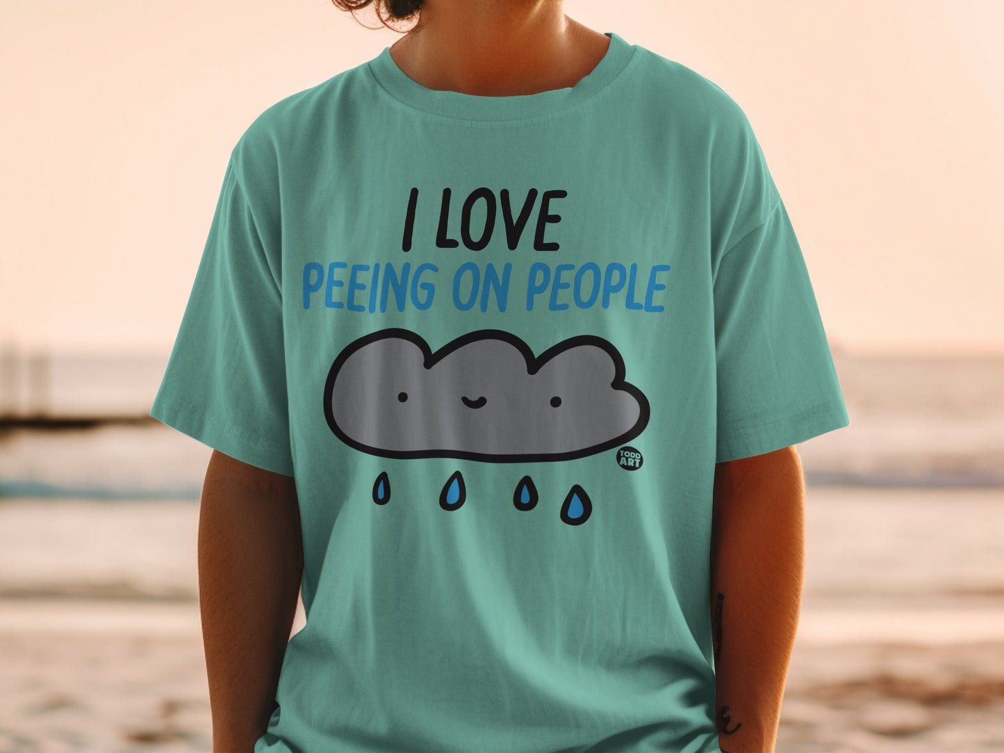 Teal t-shirt with cartoon cloud and text: I love peeing on people.