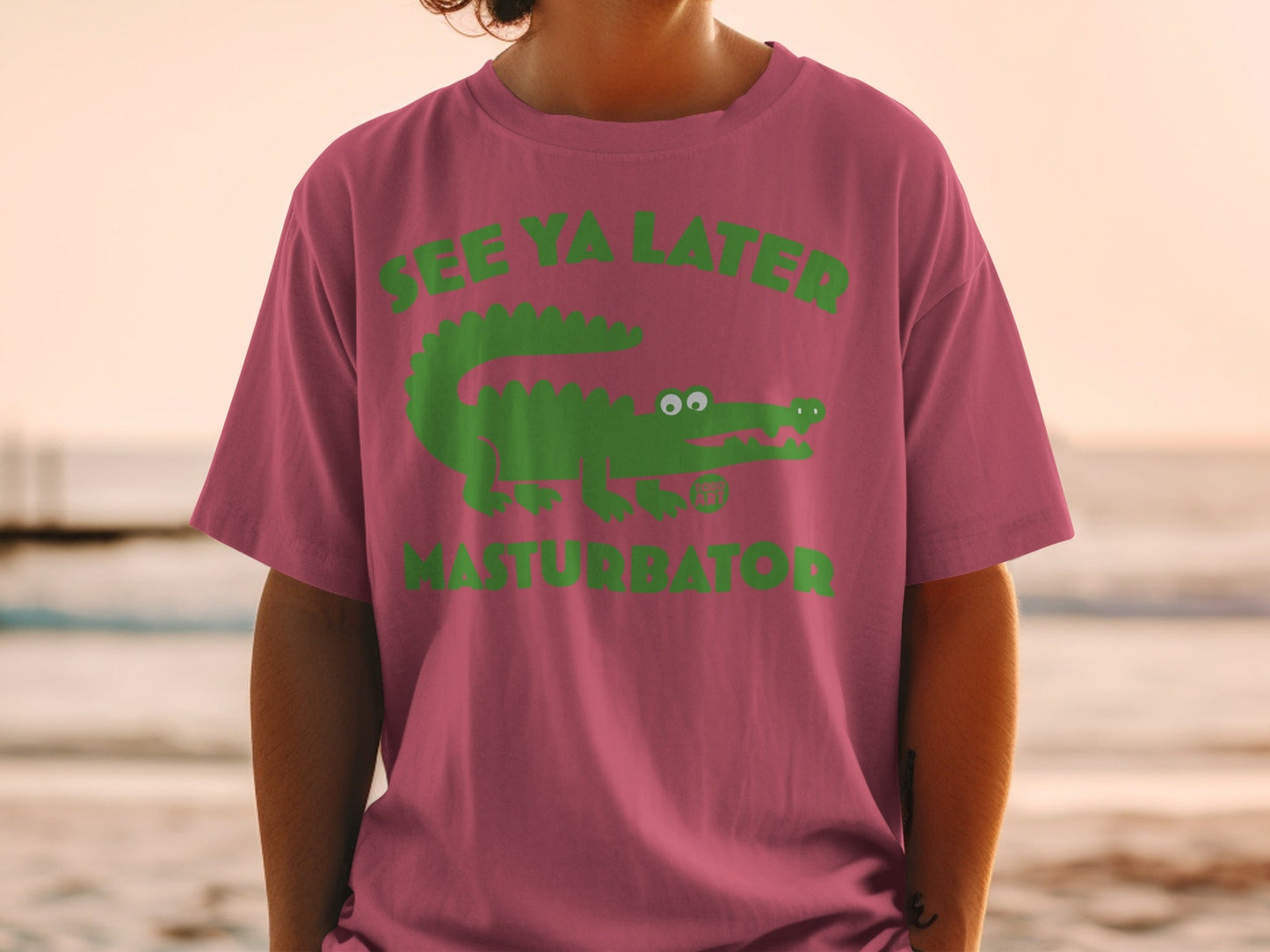 Pink t-shirt with green alligator graphic and "SEE YA LATER MASTURBATOR" text.