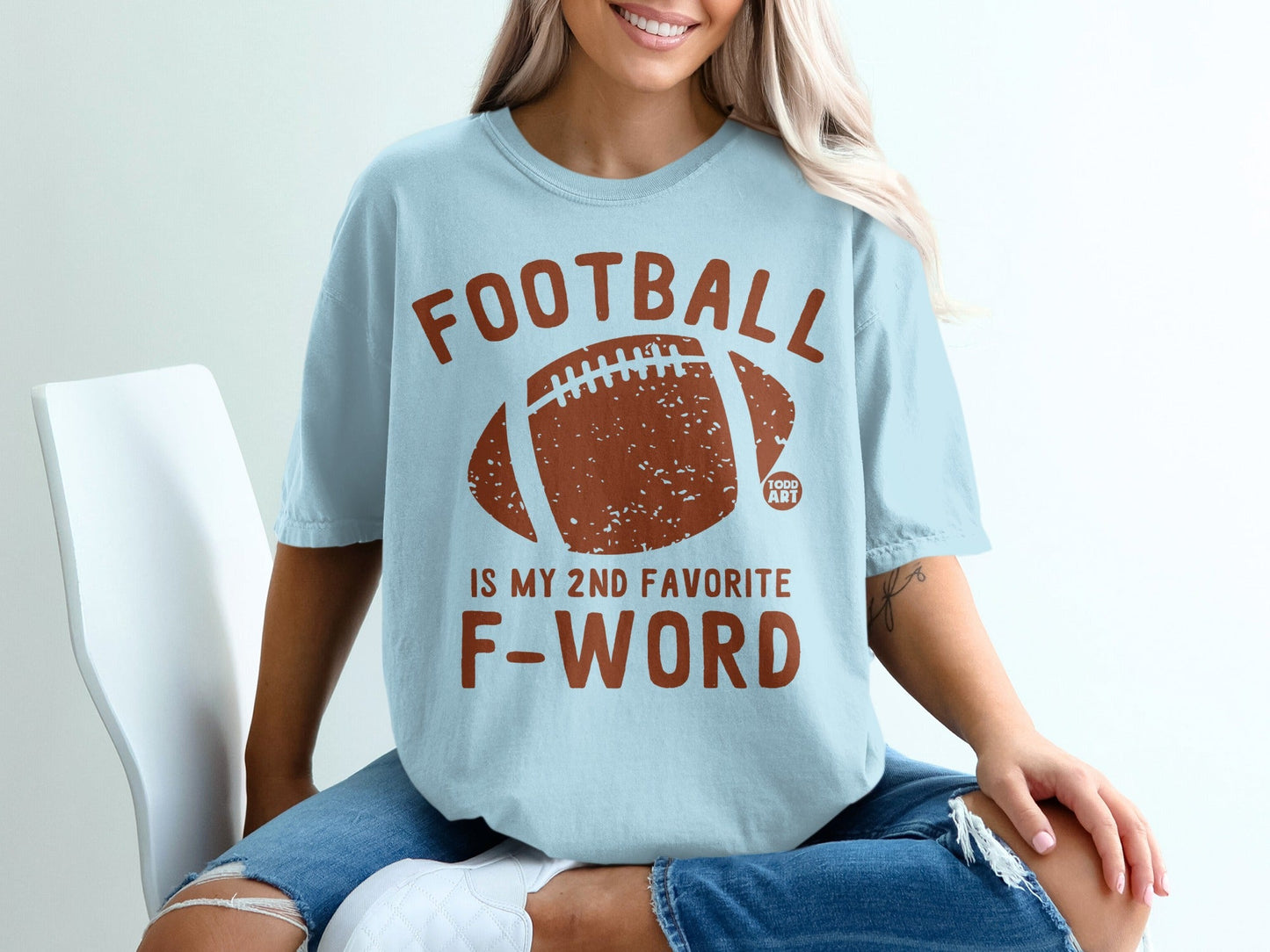 Light blue t-shirt with "FOOTBALL IS MY 2ND FAVORITE F-WORD" and football graphic.