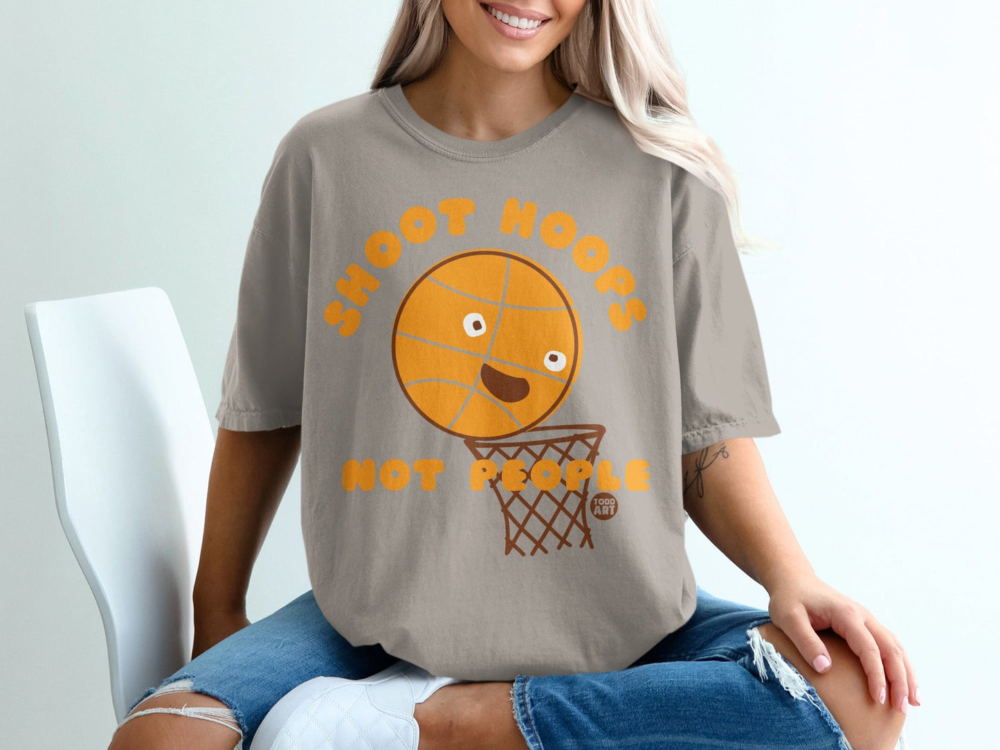 T-shirt with cartoon basketball and hoop saying "Shoot Hoops".