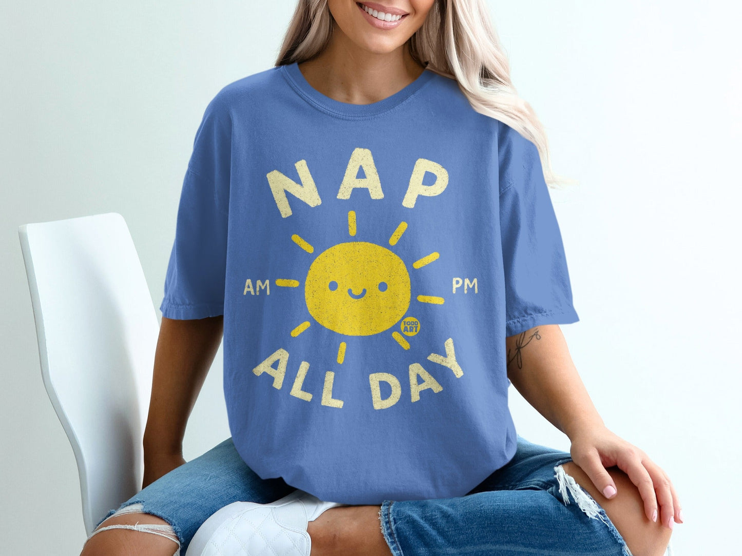 Blue t-shirt with smiling sun graphic and text "NAP ALL DAY AM PM".